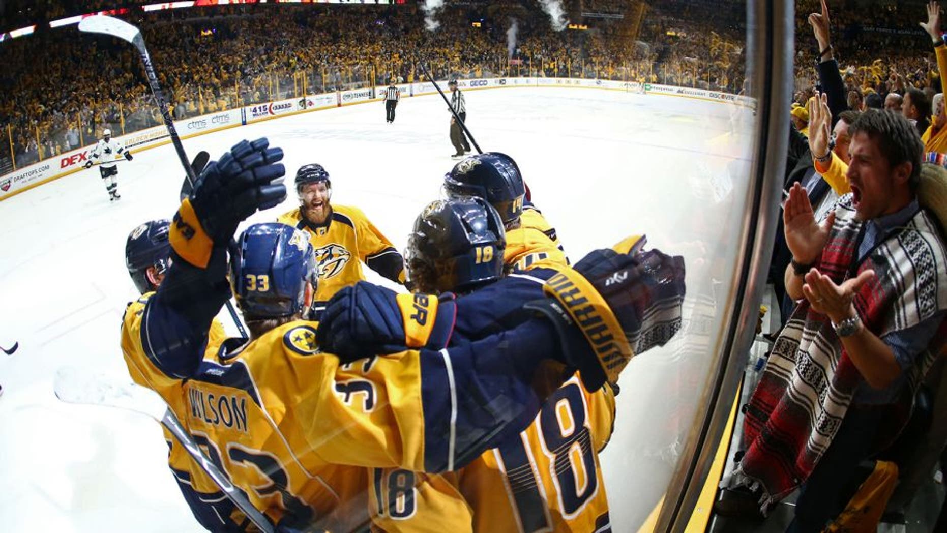May 5, 2016; Nashville, TN, USA; Nashville Predators left wing James Neal (18) celebrates with teammates along the boards after scoring a goal against the San Jose Sharks during the third period in game four of the second round of the 2016 Stanley Cup Playoffs at Bridgestone Arena. Mandatory Credit: Aaron Doster-USA TODAY Sports
