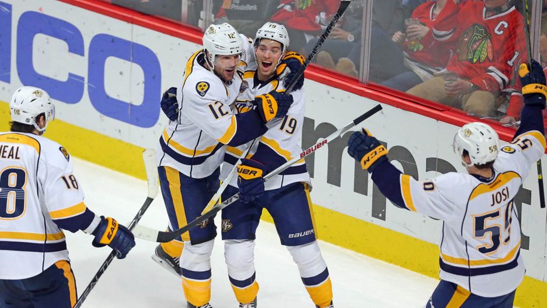 Feb 25, 2016; Chicago, IL, USA; Nashville Predators center Calle Jarnkrok (19) is congratulated for scoring by center Mike Fisher (12) and left wing James Neal (18) and defenseman Roman Josi (59) during the third period against the Chicago Blackhawks at the United Center. Nashville won 3-1. Mandatory Credit: Dennis Wierzbicki-USA TODAY Sports