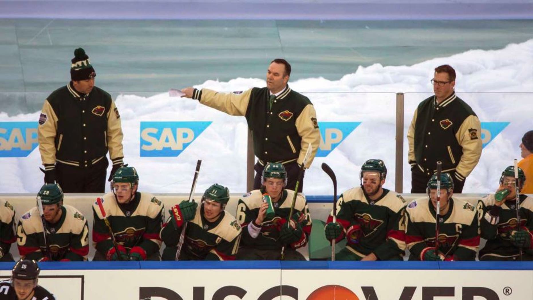 Minnesota Wild interim head coach John Torchetti stands behind the bench in the third period against the Chicago Blackhawks during a Stadium Series hockey game at TCF Bank Stadium in Minneapolis on Sunday, Feb. 21, 2016.