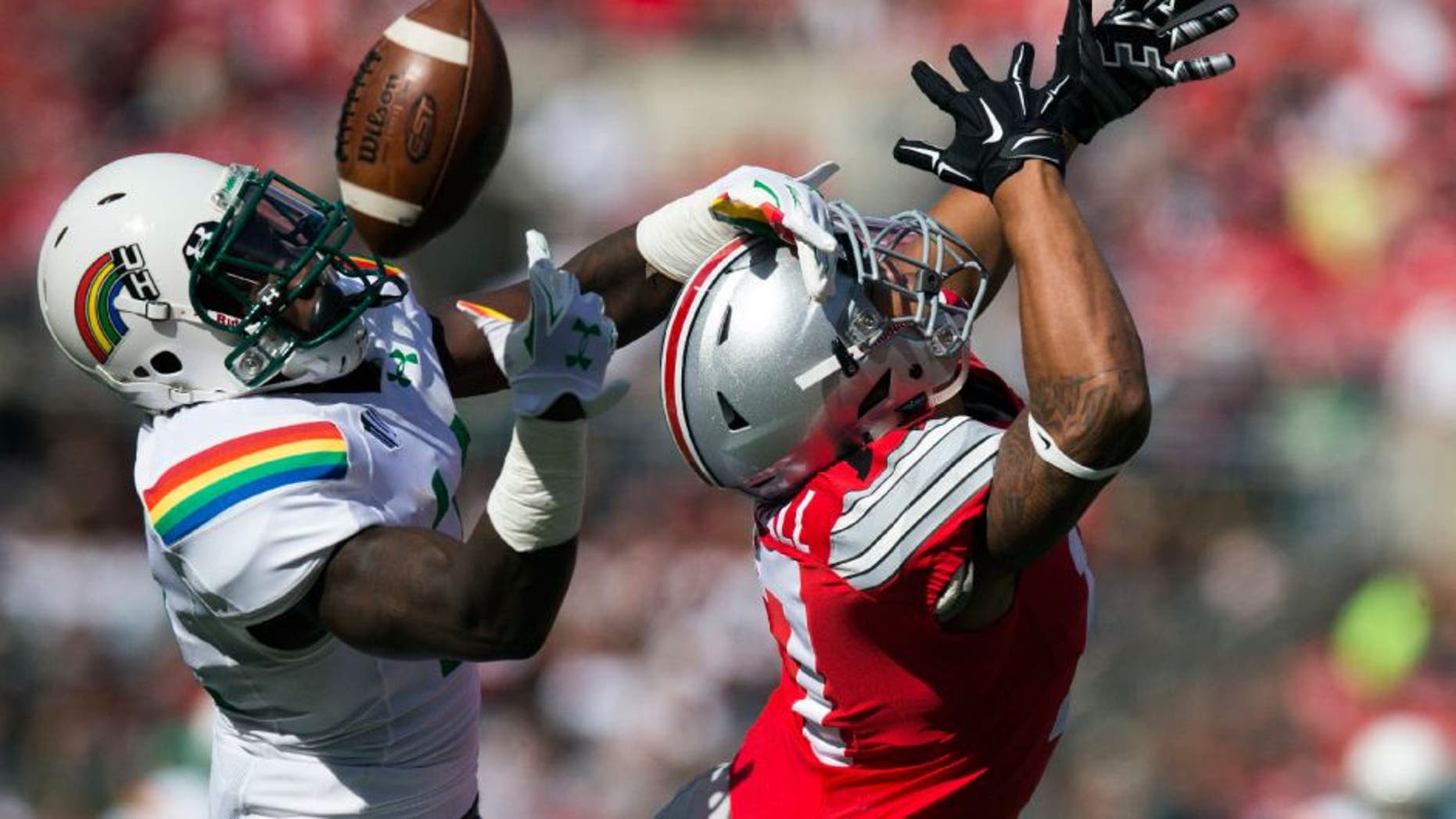 Hawaii Warriors defensive back Nick Nelson deflects a pass away from Ohio State Buckeyes running back Jalin Marshall.