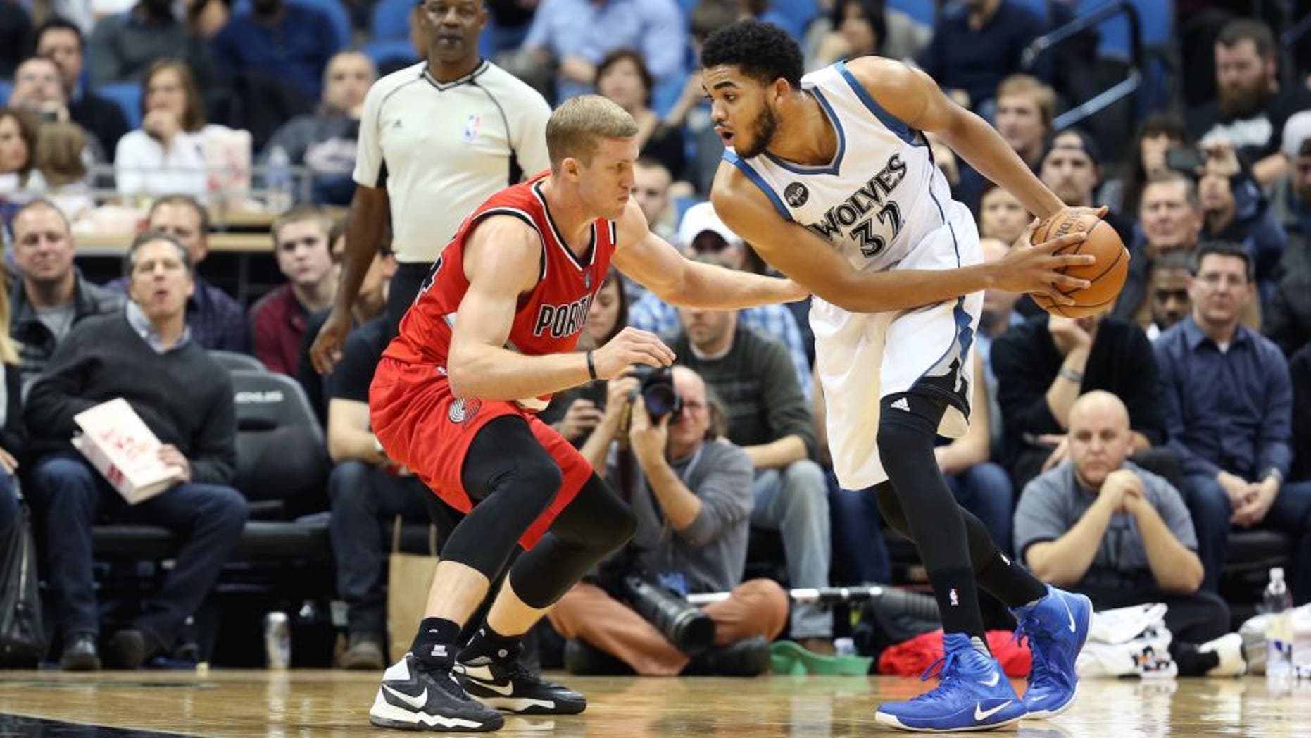 MINNEAPOLIS, MN - DECEMBER 5: Karl-Anthony Towns #32 of the Minnesota Timberwolves defends the ball against the Portland Trail Blazers during the game on December 5, 2015 at Target Center in Minneapolis, Minnesota. NOTE TO USER: User expressly acknowledges and agrees that, by downloading and or using this Photograph, user is consenting to the terms and conditions of the Getty Images License Agreement. Mandatory Copyright Notice: Copyright 2015 NBAE (Photo by Jordan Johnson/NBAE via Getty Images)