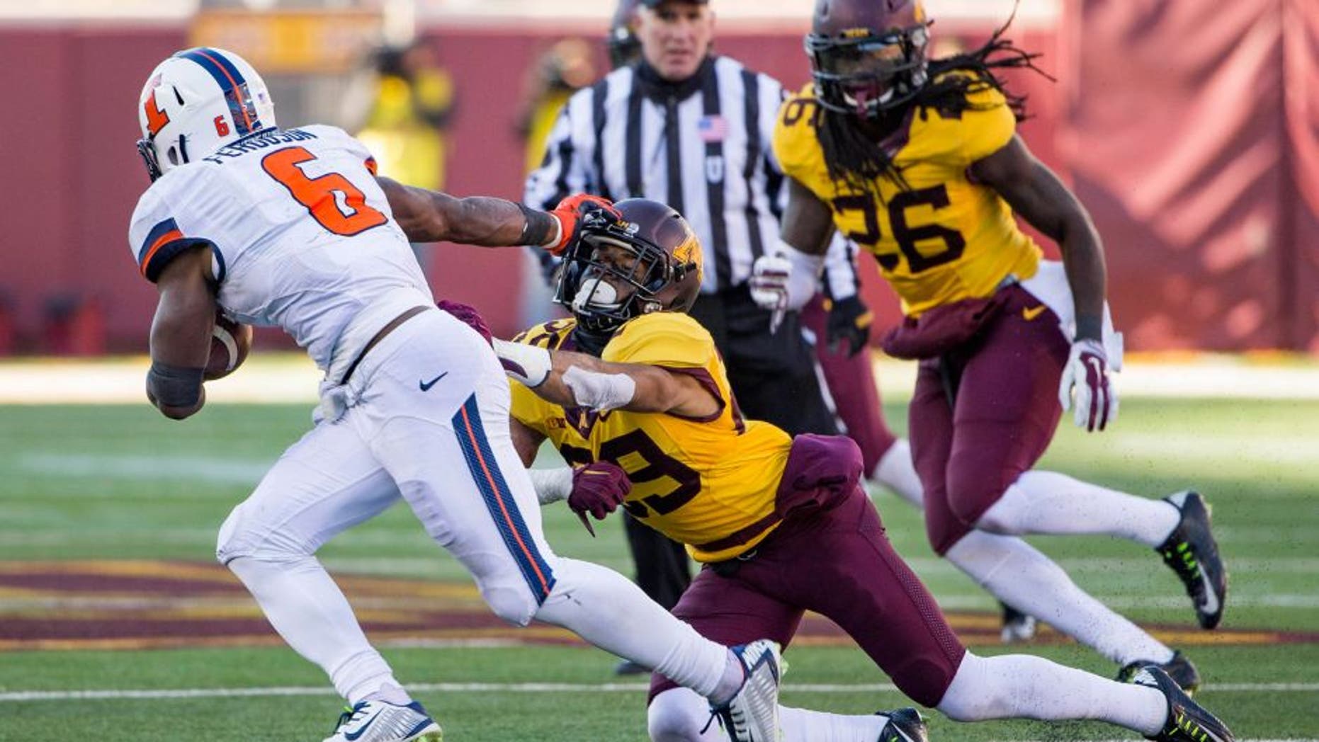 Nov 21, 2015; Minneapolis, MN, USA; Minnesota Golden Gophers defensive back Briean Boddy-Calhoun (29) gets stiff armed by Illinois Fighting Illini running back Josh Ferguson (6) in the second half at TCF Bank Stadium. The Gophers won 32-23. Mandatory Credit: Jesse Johnson-USA TODAY Sports