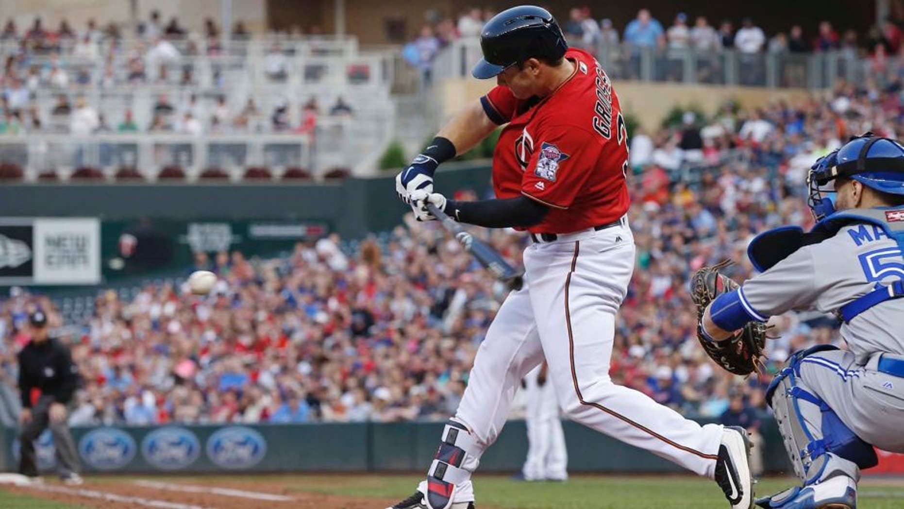 Minnesota Twins' Robbie Grossman hits an RBI double off Toronto Blue Jays pitcher Aaron Sanchez in the second inning of a baseball game Friday, May 20, 2016, in Minneapolis. (AP Photo/Jim Mone)