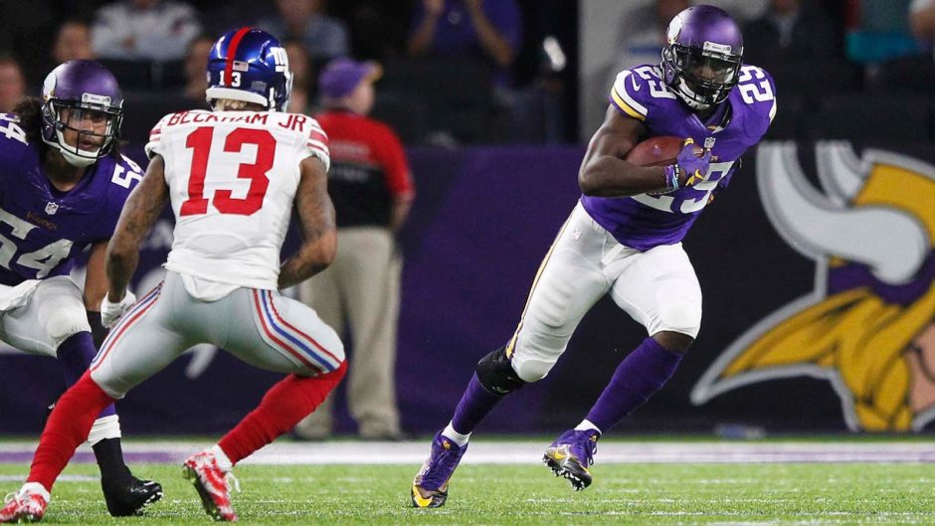 Minnesota Vikings cornerback Xavier Rhodes, right, runs from New York Giants wide receiver Odell Beckham (13) after intercepting a pass during the second half of an NFL football game Monday, Oct. 3, 2016, in Minneapolis. (AP Photo/Andy Clayton-King)