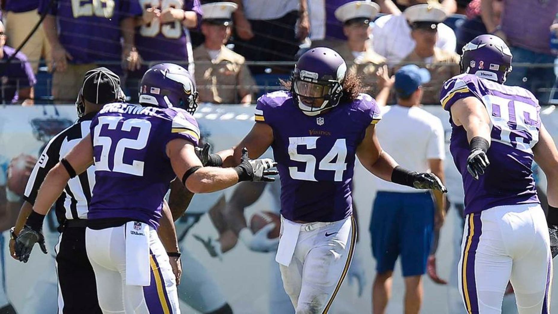 Minnesota Vikings linebacker Eric Kendricks (54) is congratulated by Chad Greenway (52) and Rhett Ellison (85) after Kendricks returned an intercepted pass 77 yards for a touchdown against the Tennessee Titans in the second half of an NFL football game Sunday, Sept. 11, 2016, in Nashville, Tenn. (AP Photo/James Kenney)
