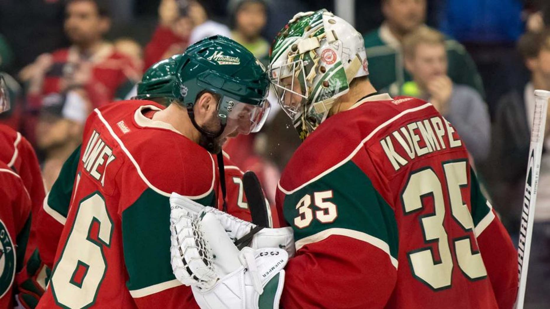 Dec 15, 2015; Saint Paul, MN, USA; Minnesota Wild forward Thomas Vanek (26) and goalie Darcy Kuemper (35) celebrate the win after the game against the Vancouver Canucks at Xcel Energy Center. The Minnesota Wild beat the Vancouver Canucks 6-2. Mandatory Credit: Brad Rempel-USA TODAY Sports