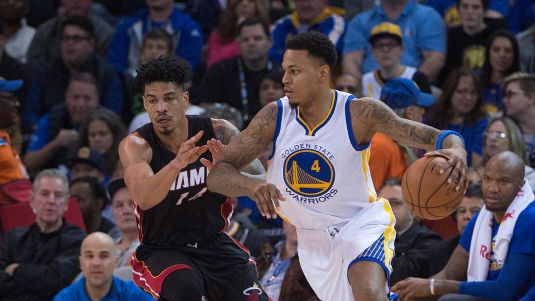 January 11, 2016; Oakland, CA, USA; Golden State Warriors forward Brandon Rush (4) dribbles the basketball against Miami Heat forward Gerald Green (14) during the second quarter at Oracle Arena. The Warriors defeated the Heat 111-103. Mandatory Credit: Kyle Terada-USA TODAY Sports