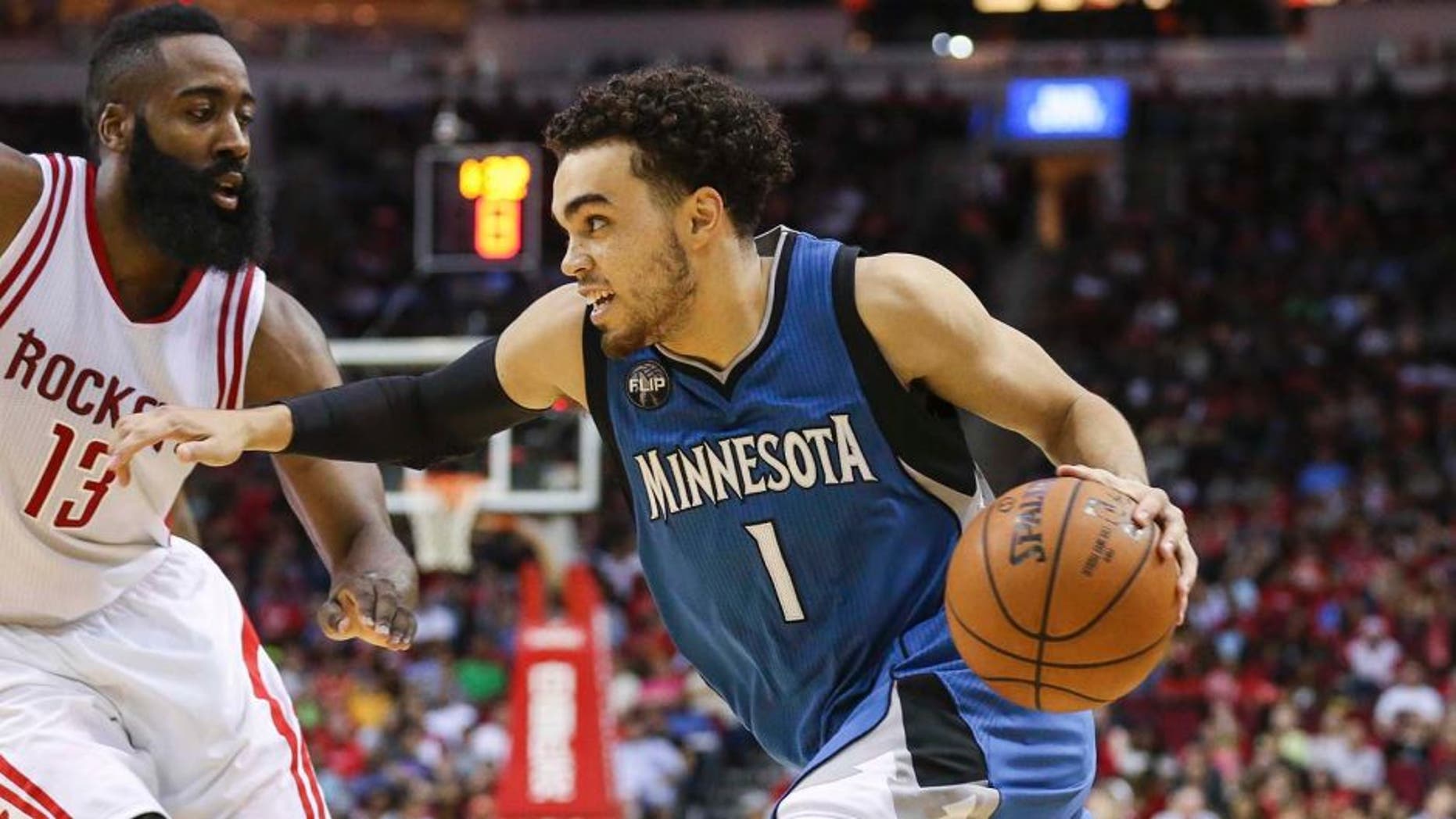 Mar 18, 2016; Houston, TX, USA; Minnesota Timberwolves guard Tyus Jones (1) dribbles the ball as Houston Rockets guard James Harden (13) defends during the third quarter at Toyota Center. Mandatory Credit: Troy Taormina-USA TODAY Sports