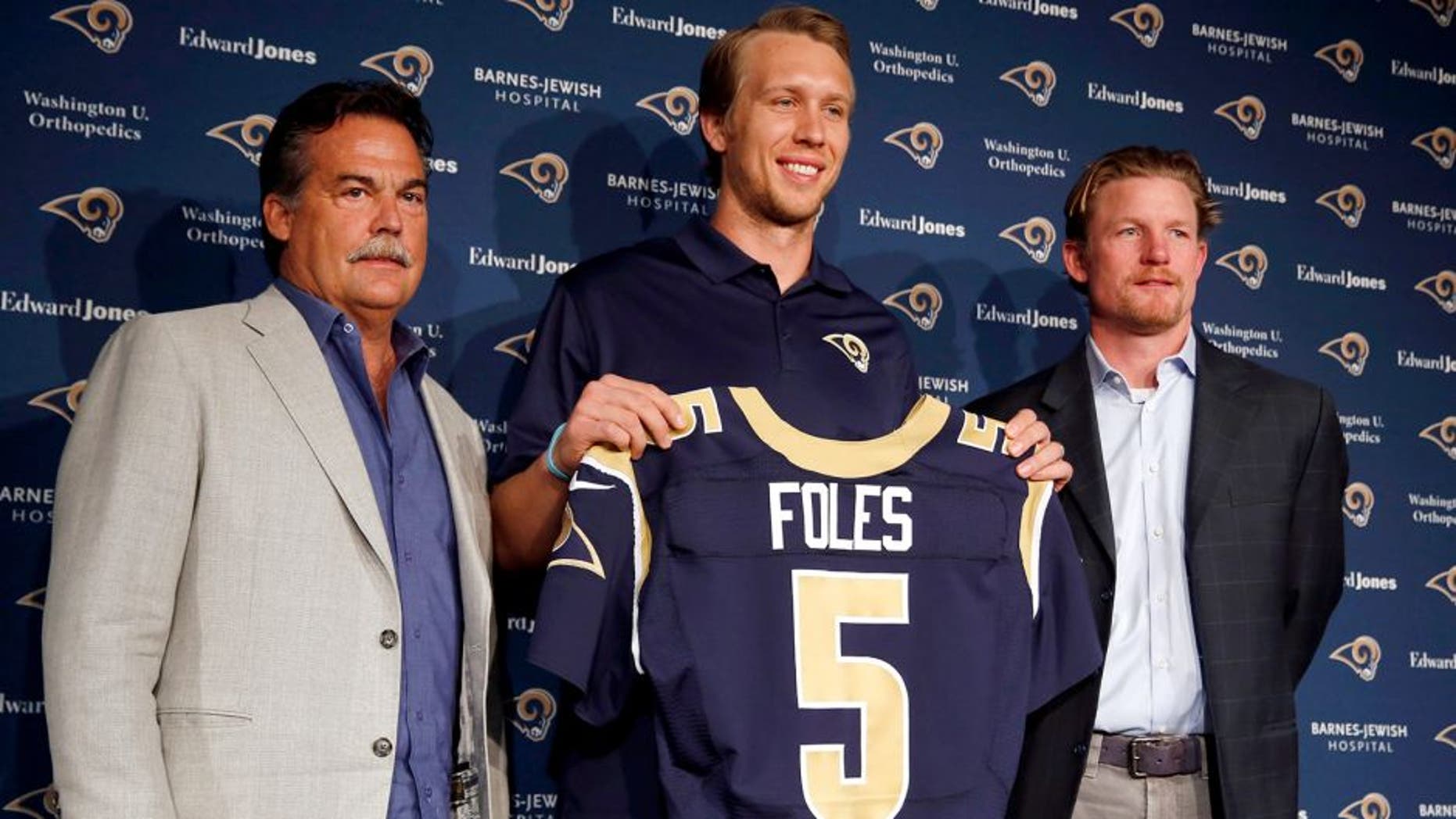 Nick Foles, center, is introduced as the new St. Louis Rams quarterback by Rams head coach Jeff Fisher, left, and general manger Les Snead, right, during an NFL fooball news conference Friday, March 13, 2015, in St. Louis. Foles was traded to the Rams earlier this week, with Sam Bradford going to the Philadelphia Eagles in a quarterback swap. (AP Photo/Jeff Roberson)
