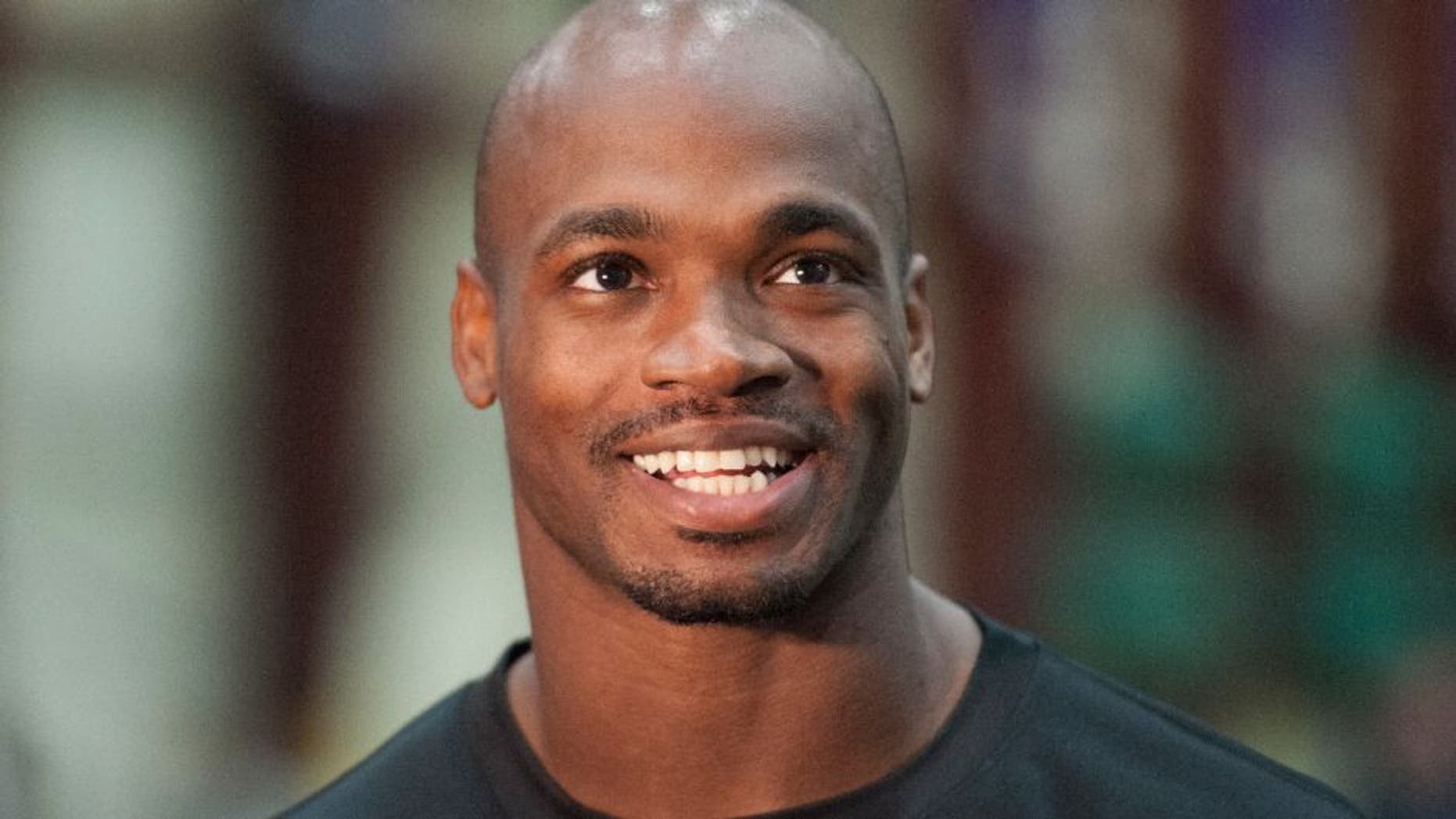 Minnesota Vikings running back Adrian Peterson talks with reporters after NFL football practice in Eden Prairie, Minn.