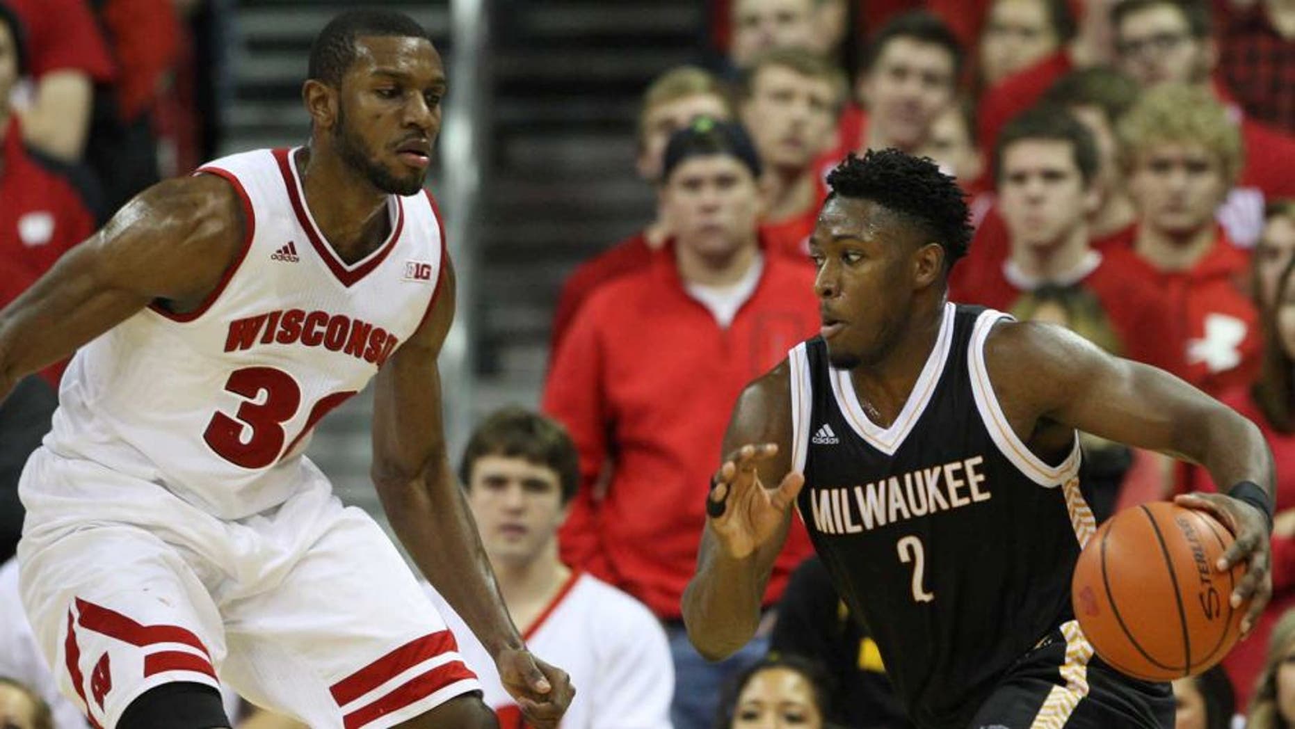 Dec 9, 2015; Madison, WI, USA; Wisconsin-Milwaukee Panthers guard Akeem Springs (2) drive the ball against Wisconsin Badgers forward Vitto Brown (30) at the Kohl Center. Wisconsin-Milwaukee defeated Wisconsin 68-67. Mandatory Credit: Mary Langenfeld-USA TODAY Sports