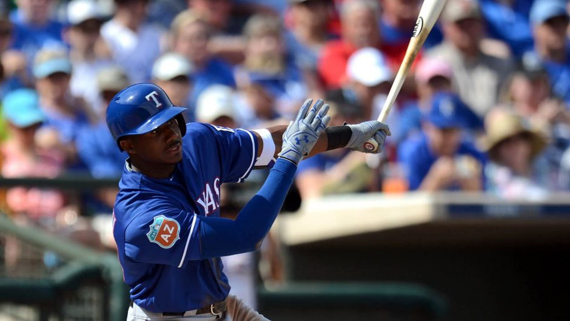 Mar 3, 2016; Surprise, AZ, USA; Texas Rangers center fielder Lewis Brinson (70) swings at a pitch during the second inning against the Kansas City Royals at Surprise Stadium. Mandatory Credit: Joe Camporeale-USA TODAY Sports