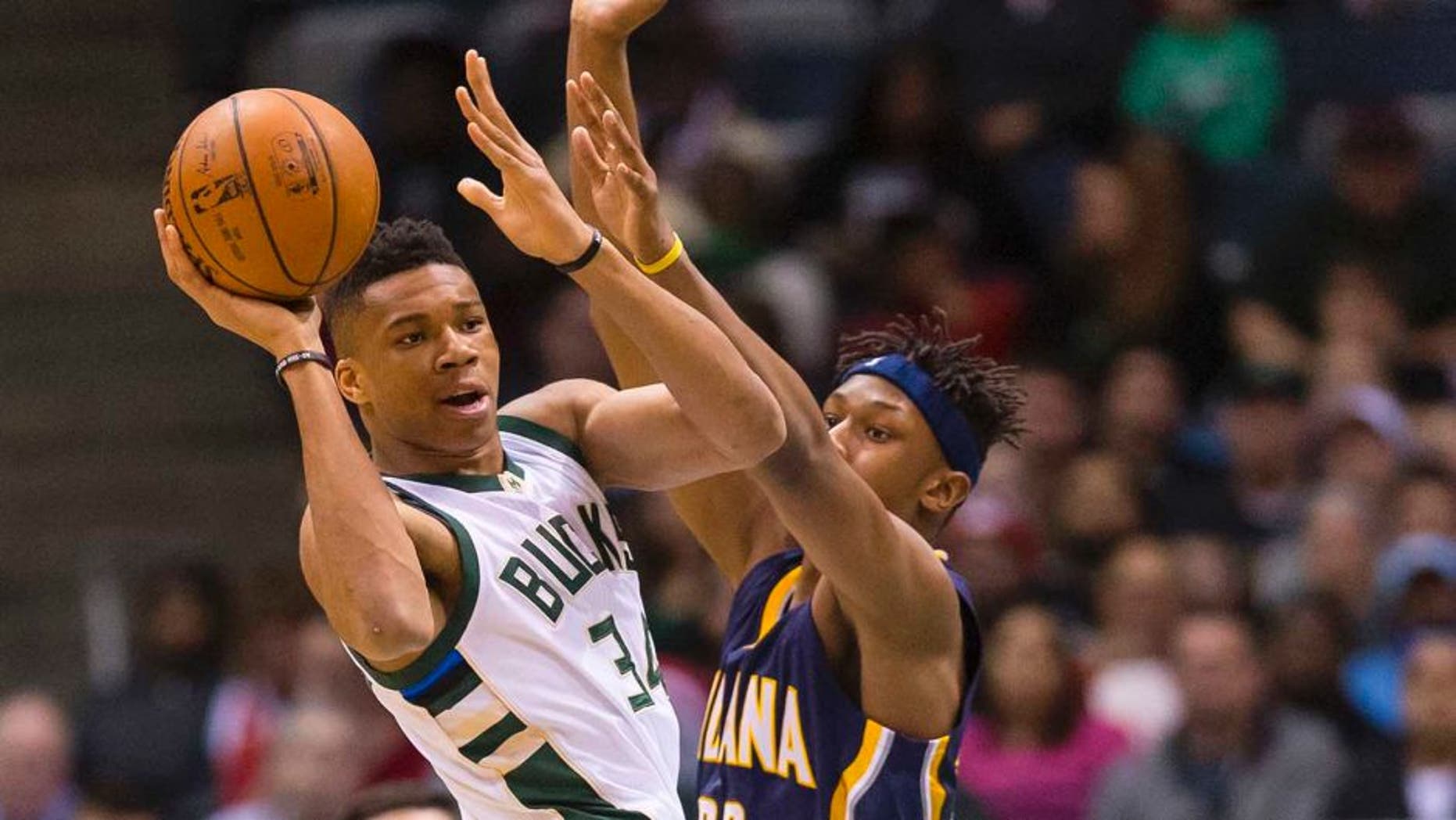Apr 13, 2016; Milwaukee, WI, USA; Milwaukee Bucks forward Giannis Antetokounmpo (34) passes the ball as Indiana Pacers forward Myles Turner (33) defends during the first quarter at BMO Harris Bradley Center. Mandatory Credit: Jeff Hanisch-USA TODAY Sports