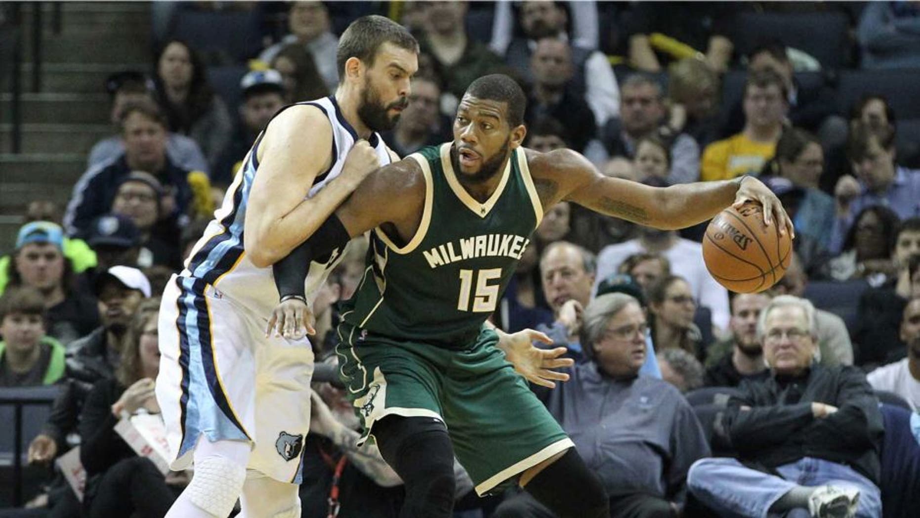 Jan 28, 2016; Memphis, TN, USA; Milwaukee Bucks center Greg Monroe (15) dribbles the ball as Memphis Grizzlies center Marc Gasol (33) defends in the second quarter at FedExForum. Mandatory Credit: Nelson Chenault-USA TODAY Sports