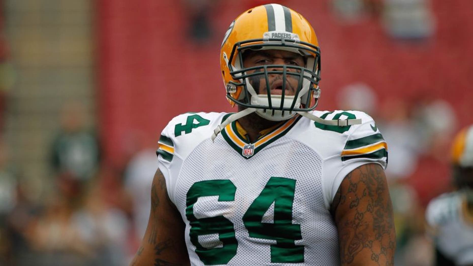 Dec 21, 2014; Tampa, FL, USA; Green Bay Packers defensive tackle Mike Pennel (64) against the Tampa Bay Buccaneers works out prior to the game against the Tampa Bay Buccaneers at Raymond James Stadium. Mandatory Credit: Kim Klement-USA TODAY Sports