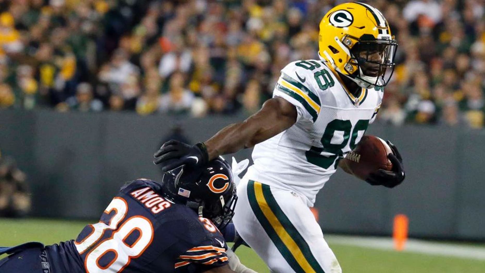 Green Bay Packers wide receiver Ty Montgomery (88) pushes Chicago Bears free safety Adrian Amos (38) away as he carries the ball during the first half of an NFL football game, Thursday, Oct. 20, 2016, in Green Bay, Wis. (AP Photo/Mike Roemer)