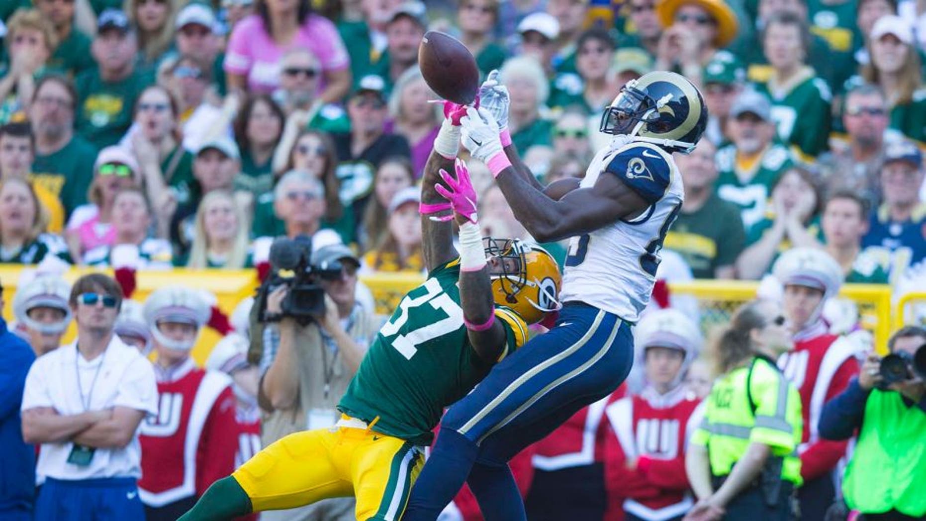 Oct 11, 2015; Green Bay, WI, USA; Green Bay Packers cornerback Sam Shields (37) breaks up the pass intended for St. Louis Rams wide receiver Brian Quick (83) during the second quarter at Lambeau Field. Mandatory Credit: Jeff Hanisch-USA TODAY Sports