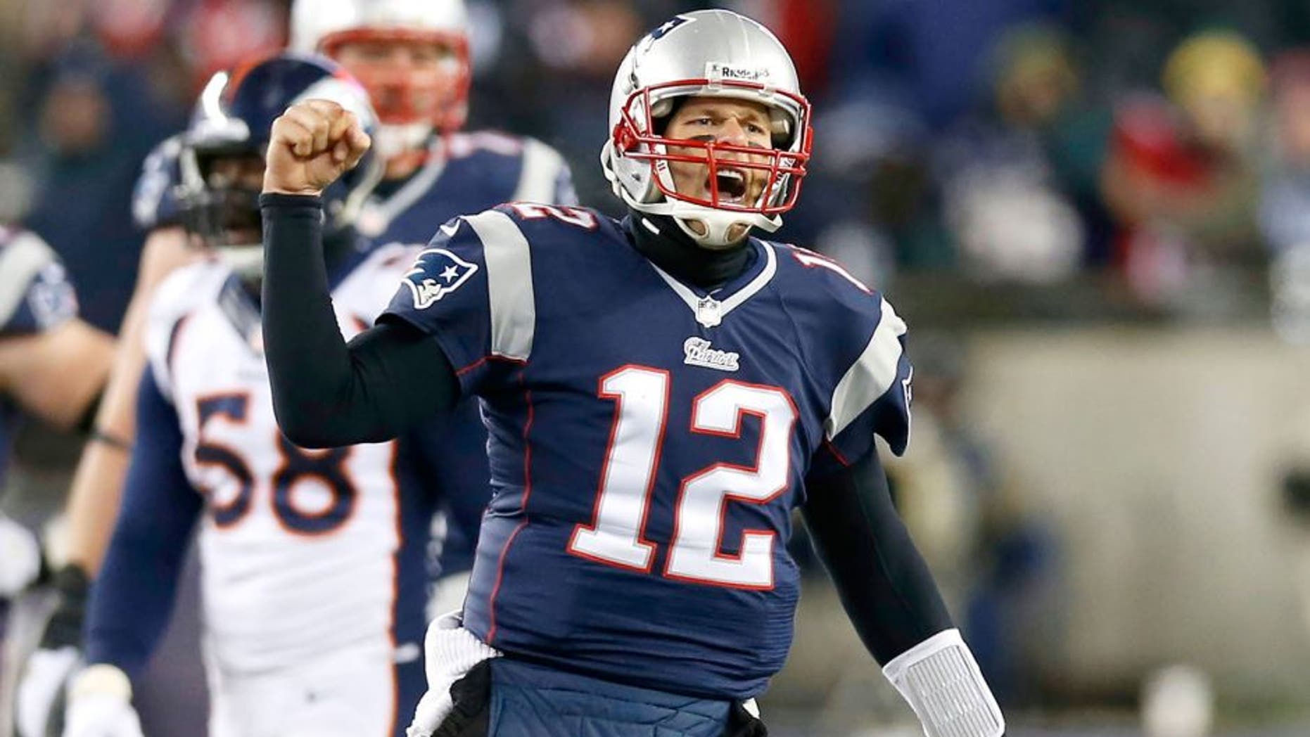 Nov 24, 2013; Foxborough, MA, USA; New England Patriots quarterback Tom Brady (12) reacts after a completed pass against the Denver Broncos during overtime at Gillette Stadium Stadium. Mandatory Credit: Greg M. Cooper-USA TODAY Sports