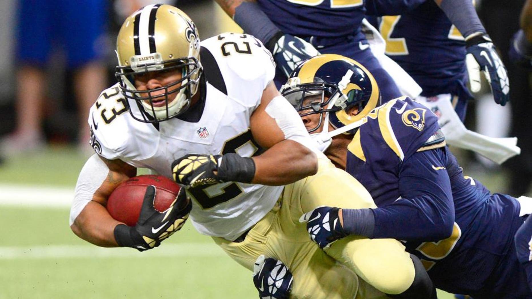 Dec 15, 2013; St. Louis, MO, USA; New Orleans Saints running back Pierre Thomas (23) is tackled by St. Louis Rams free safety Rodney McLeod (23) during the first half at the Edward Jones Dome. The Rams defeated the Saints 27-16. Mandatory Credit: Jeff Curry-USA TODAY Sports
