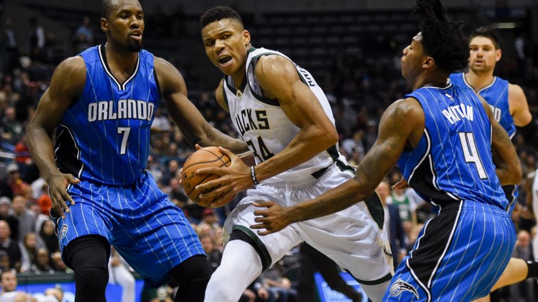 Nov 21, 2016; Milwaukee, WI, USA; Milwaukee Bucks forward Giannis Antetokounmpo (34) drives for the basket against Orlando Magic forward Serge Ibaka (7) and guard Elfrid Payton (4) in the fourth quarter at BMO Harris Bradley Center. Mandatory Credit: Benny Sieu-USA TODAY Sports