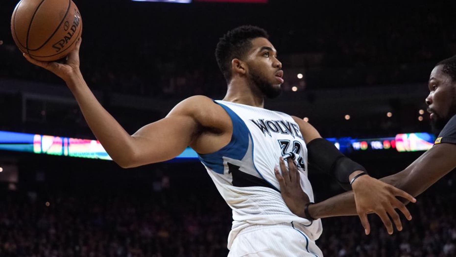 Nov 26, 2016; Oakland, CA, USA; Minnesota Timberwolves center Karl-Anthony Towns (32) controls the ball against Golden State Warriors forward Kevin Durant (35) during the first quarter at Oracle Arena. Mandatory Credit: Kelley L Cox-USA TODAY Sports