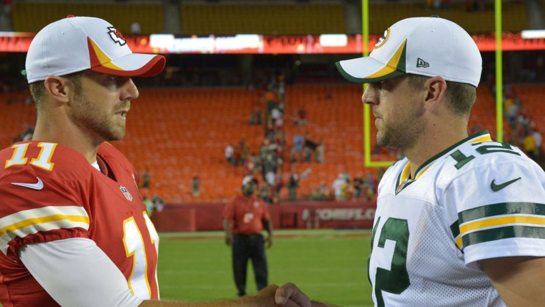 Aug 29, 2013; Kansas City, MO, USA; Kansas City Chiefs quarterback Alex Smith (11) talks with Green Bay Packers quarterback Aaron Rodgers (12) after the game at Arrowhead Stadium. The Chiefs won 30-8. Mandatory Credit: Denny Medley-USA TODAY Sports