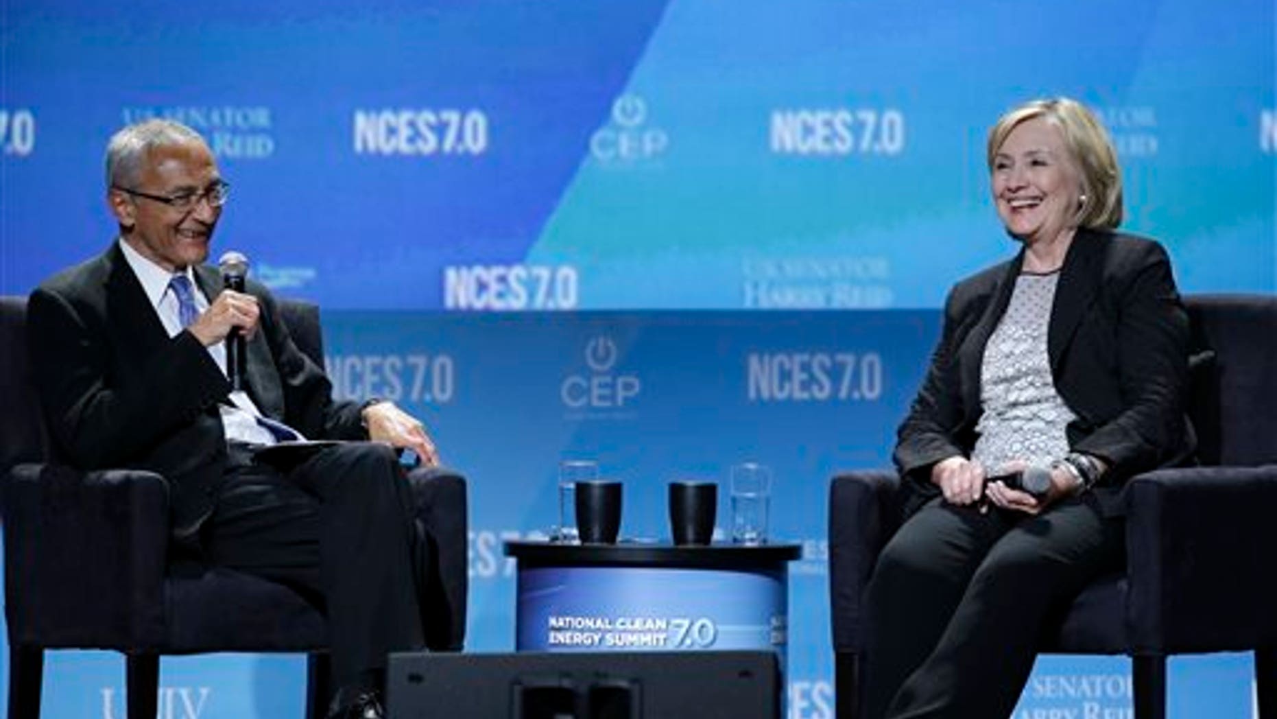 Former Secretary of State Hillary Rodham Clinton, right, takes questions from John Podesta, counselor to President Barack Obama, at the National Clean Energy Summit Thursday, Sept. 4, 2014, in Las Vegas. (AP Photo/John Locher)