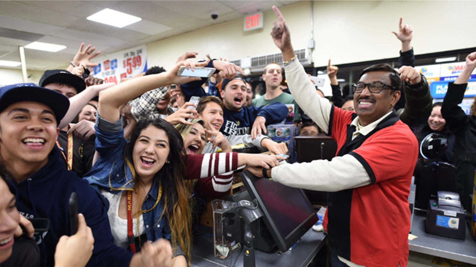 FILE -This Jan. 13, 2016 file photo shows 7-Eleven store clerk M. Faroqui celebrates with customers after learning the store sold a winning Powerball ticket in Chino Hills, Calif. The California lottery said Tuesday, July 19, 2016, a couple, Marvin and Mae Acosta, have claimed a $528.8 million share of a record record $1.6 billion Powerball jackpot in January. (Will Lester/The Sun via AP, File) MANDATORY CREDIT
