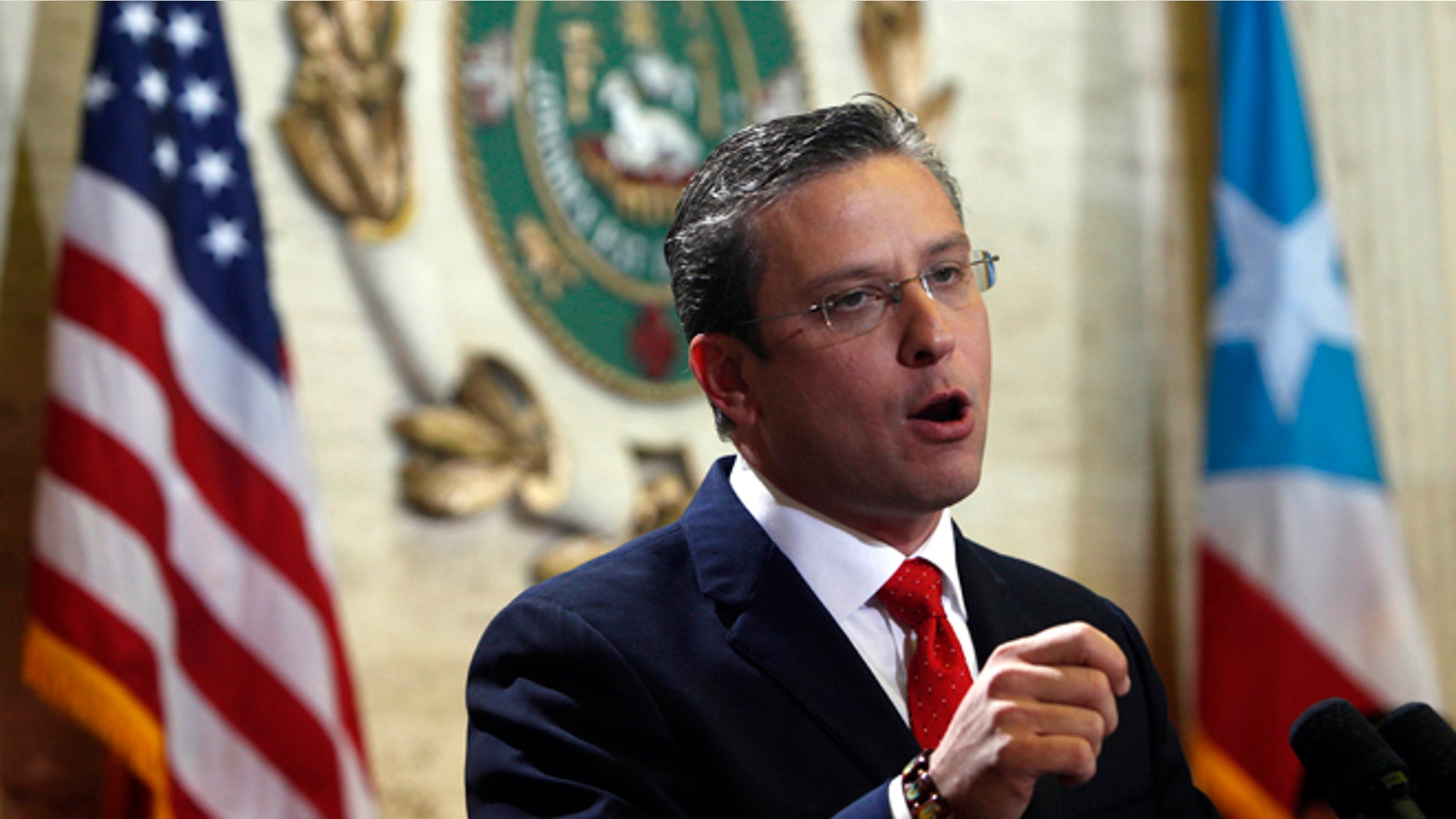 FILE - In this April 25, 2013 file photo, Puerto Rico Gov. Alejandro Garcia Padilla speaks during a state of the commonwealth address at the Capitol building in San Juan, Puerto Rico. A new plan backed by Garcia aims to boost revenue and tackle the U.S. territorys spiraling public debt by creating a 16 percent value-added tax, or VAT. If approved, manufacturers would pay the tax on raw materials and include it in the price of the product sold to retailers, who then would pass it on to consumers. (AP Photo/Ricardo Arduengo, File)