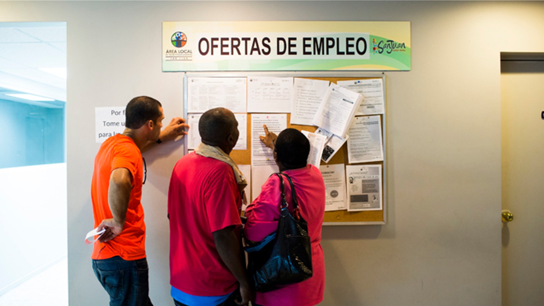 SAN JUAN, PUERTO RICO - NOVEMBER 14: People scan the bulletin board for job postings at the unemployment office on November 14, 2013 in San Juan, Puerto Rico. The unemployment rate hovers around 14 percent, almost twice the national average. The island-territory of the United States is on the brink of a debt crisis as lending has skyrocketed in the last decade with the government issuing municipal bonds. Market analysts have rated those bonds as junk and suspect it's 70 billion dollar debt might be unserviceable in the near future. With a deteriorating manufacturing industry and tourism only contributing to 10 percent of the GDP, the way out is unclear. (Photo by Christopher Gregory/Getty Images)
