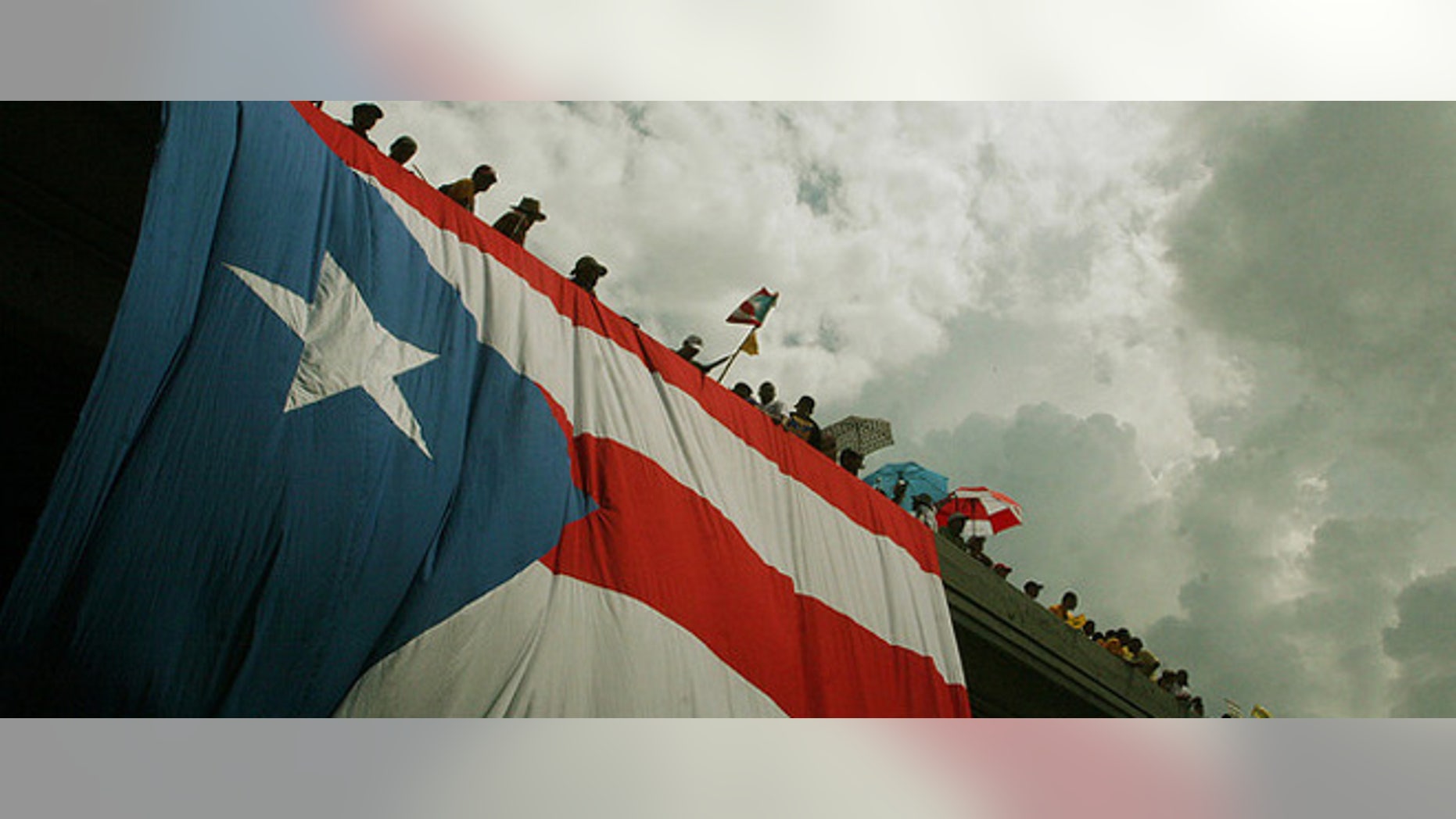 (October 15th, 2009) Thousands of protestors flooded the streets in the largest public gathering in Puerto Rican history. The massive strike was in response to the republican governor Luis Fortuâo's decision to lay off 16,720 public workers. ~ San Juan, Puerto Rico ~ Photo © 2009 Ricardo Figueroa
