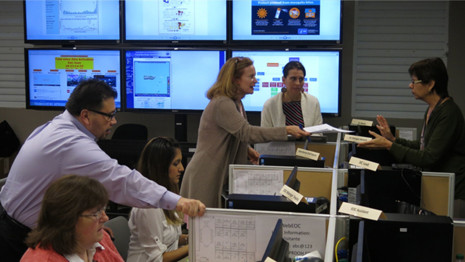 FILE - In this Feb. 24, 2016 file photo, workers from the Puerto Rico Health Department and the Centers for Disease Control and Prevention review Zika-related data collected by the island's health department and the CDC in San Juan, Puerto Rico. On Friday, June 17, 2016, Dr. Tom Frieden, the director of the CDC, is warning that dozens or hundreds of babies in Puerto Rico could develop severe birth defects because of the virus, based on how an outbreak is playing out there. (AP Photo/Danica Coto)