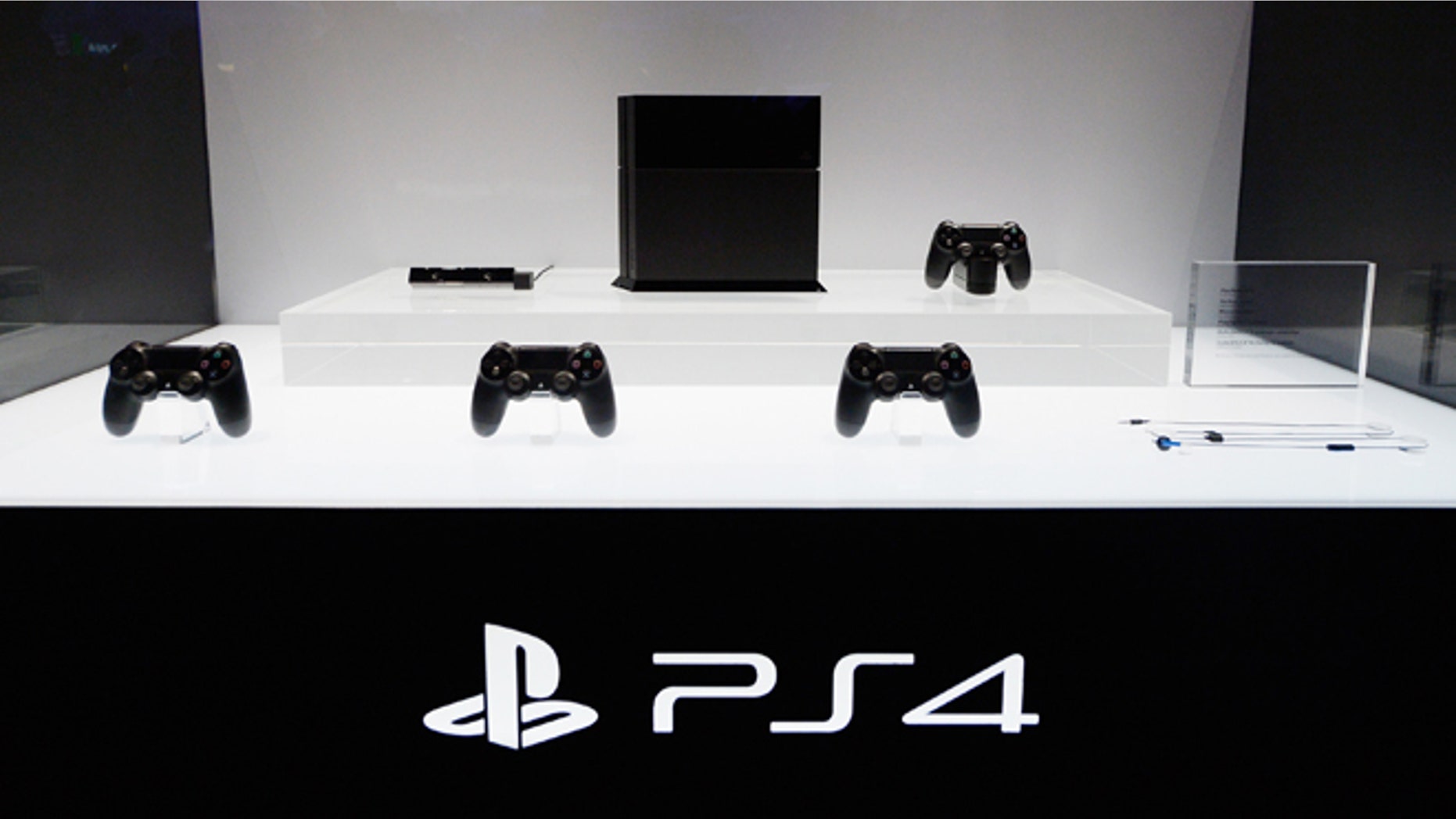 LOS ANGELES, CA - JUNE 11: A Playstation 4 and its controllers on display at the Sony Playstation E3 2013 booth at the Los Angeles Convention Center on June 11, 2013 in Los Angeles, California. Thousands are expected to attend the annual three-day convention to see the latest games and announcements from the gaming industry. (Photo by Kevork Djansezian/Getty Images)