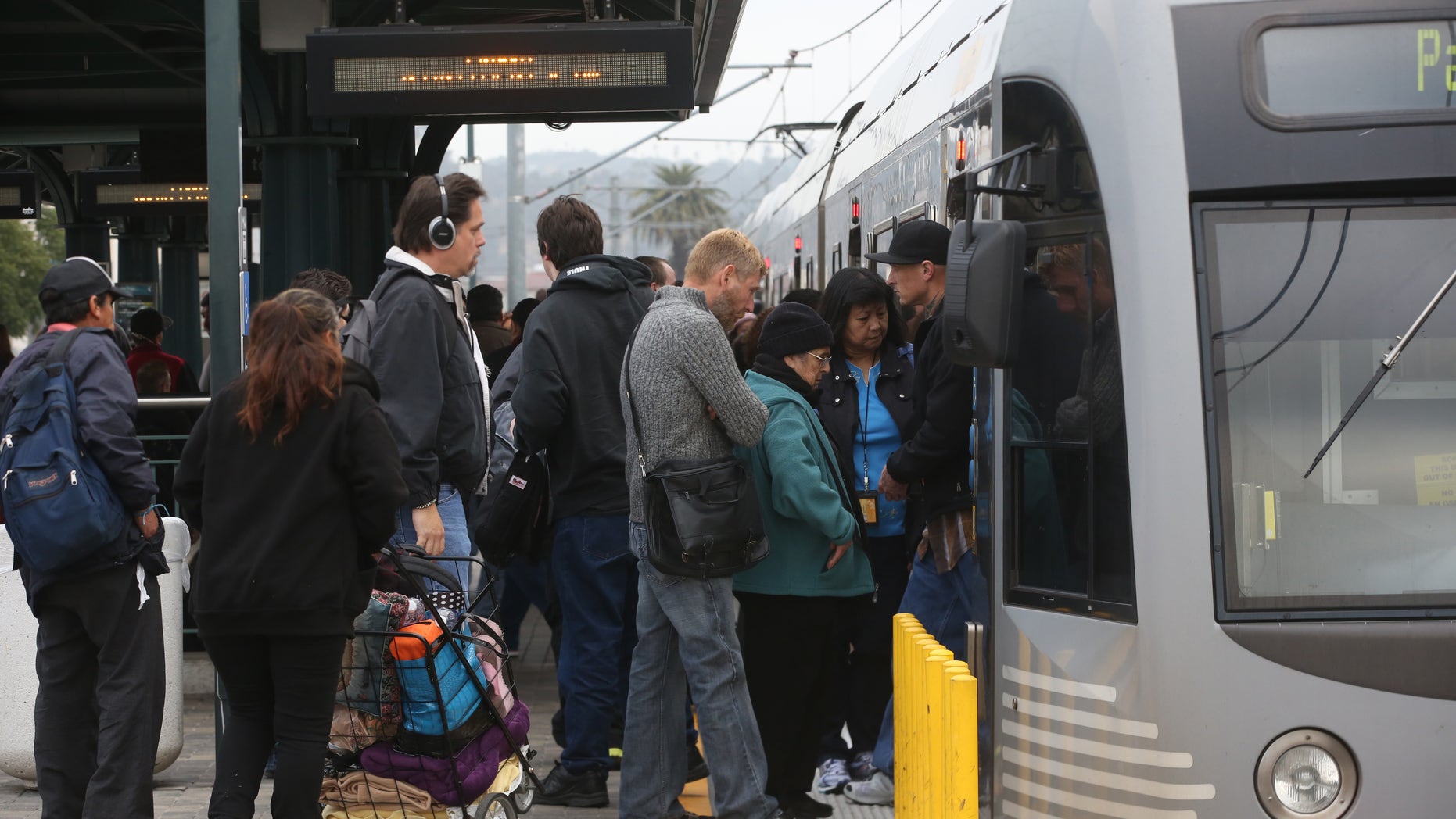 Pedestrians board a train at Union Station Friday March 7, 2014 in Los Angeles. Americans are boarding public buses, trains and subways in greater numbers than any time since the suburbs began to boom. Nearly 10.7 billion trips in 2013, to be precise, the highest number since 1956. (AP Photo/Nick Ut)
