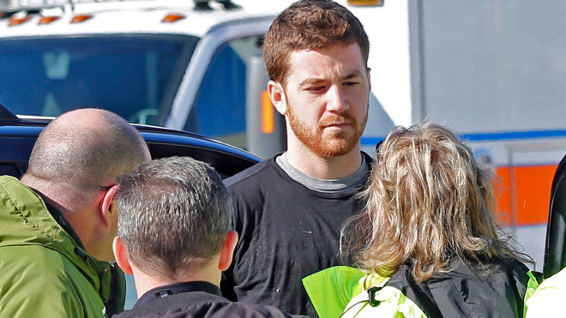 EMS personnel speak with Cody Cousins, 23, who was detained after a shooting inside the Electrical Engineering building on the campus of Purdue University in West Lafayette, Ind.