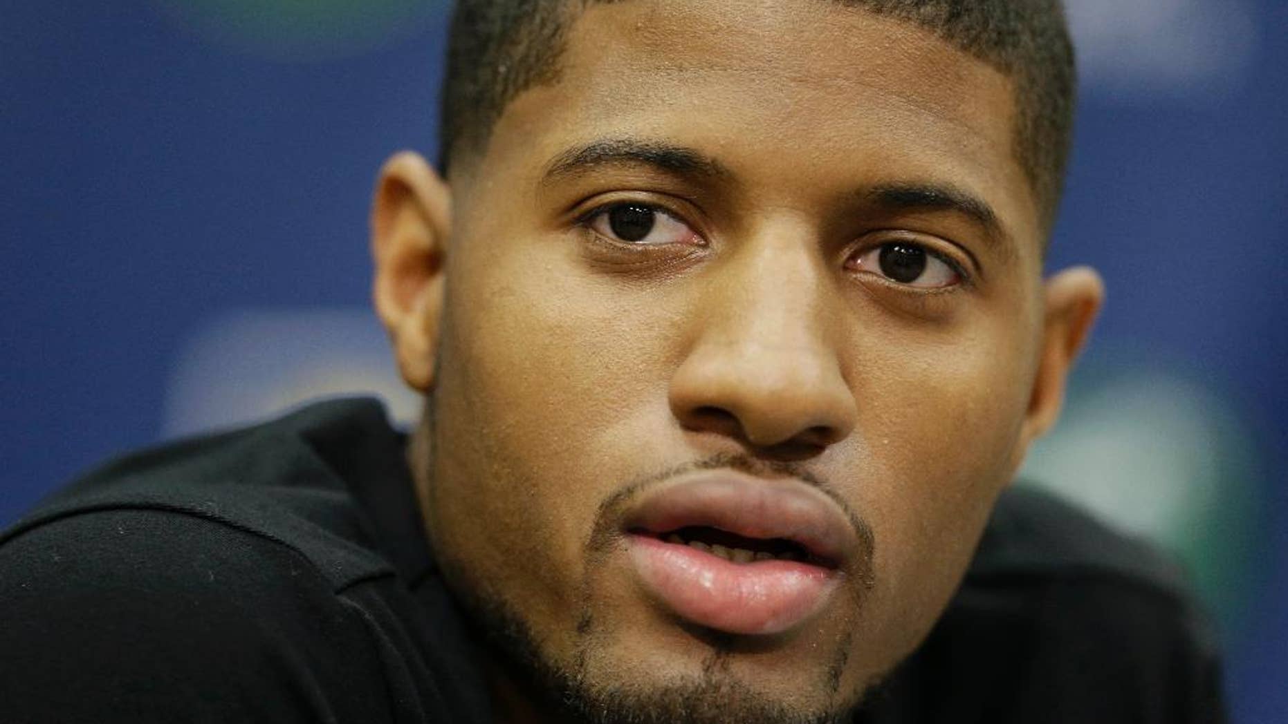 FILE - In this Aug. 15, 2014, file photo, Indiana Pacers' Paul George responds to a question during a news conference in Indianapolis. Paul George defended Ray Rice on Twitter, Thursday, Sept. 11, 2014, then backtracked less than an hour later by deleting the posts and apologizing to women and victims of domestic violence. (AP Photo/Darron Cummings, File)