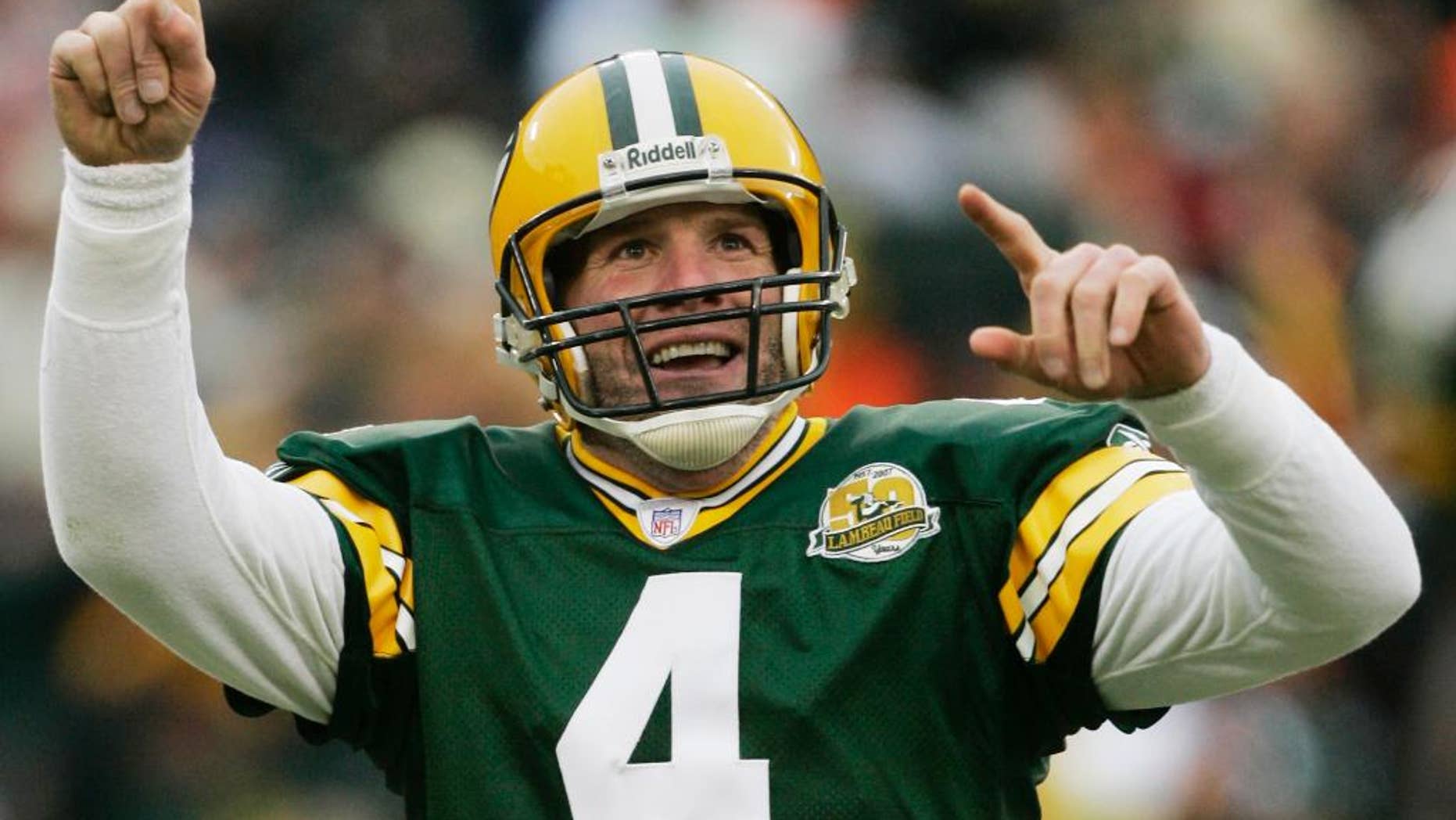 FILE - In this Dec. 9, 2007 file photo, Green Bay Packers quarterback Brett Favre reacts to a 46-yard touchdown pass to tight end Donald Lee during the second half of an NFL football game against the Oakland Raiders in Green Bay, Wis. Favre will be inducted into the team's Hall of Fame and have his jersey retired next year. Favre writes on his official website that it will be an honor to have his name placed among others such Bart Starr, Curly Lambeau, Ray Nitschke and Vince Lombardi, to name a few. (AP Photo/Morry Gash, File)
