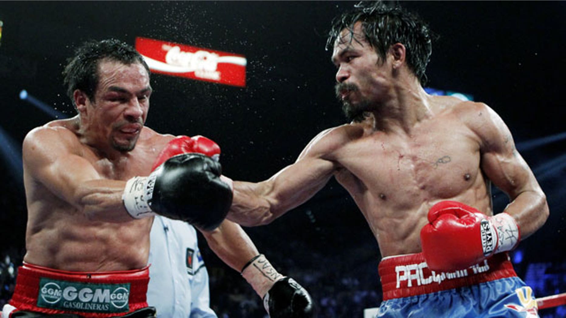 November 12, 2011: Manny Pacquiao, right, of the Philippines, hits Mexico's Juan Manuel Marquez during a WBO welterweight title fight in Las Vegas.