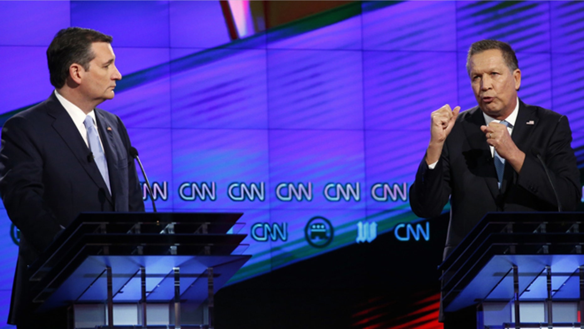 FILE - In this March 10, 2016, file photo, Republican presidential candidate Ohio Gov. John Kasich, right, speaks as Republican presidential candidate, Sen. Ted Cruz, R-Texas, listens, during a Republican presidential debate sponsored by CNN, Salem Media Group and the Washington Times at the University of Miami in Coral Gables, Fla. Declaring the Republican presidential contest at "a fork in the road," Cruz and Kasich defended their extraordinary new alliance on April 25 as the party's last, best chance to stop Donald Trump, even as the New York billionaire surged toward another big delegate haul. (AP Photo/Wilfredo Lee, File)