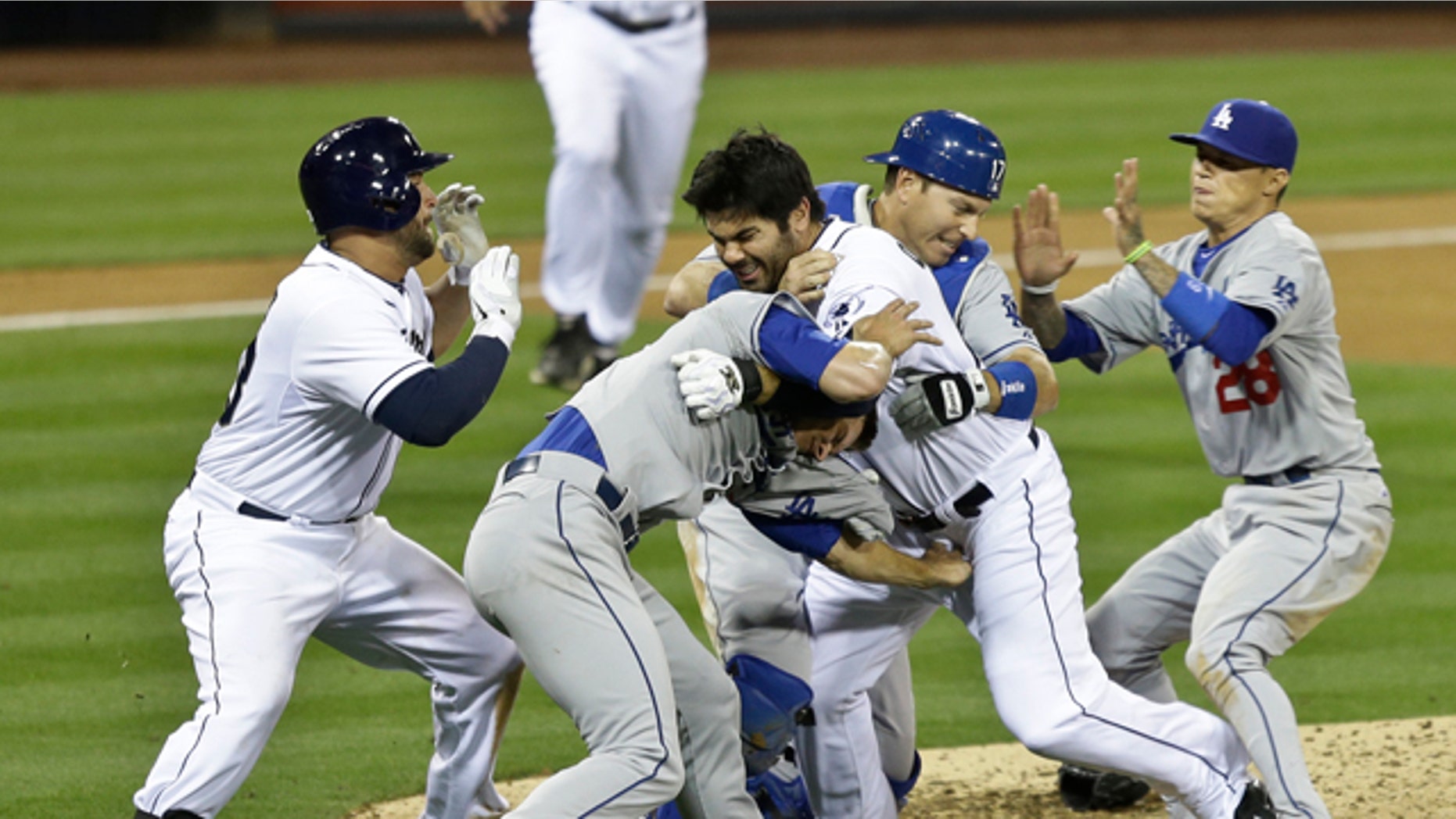 April 11, 2013: San Diego Padres' Carlos Quentin, center, and teammates battle the Los Angeles Dodgers after Quentin was hit by a pitch thrown by Angeles Dodgers pitcher Zack Greinke in the sixth inning of baseball game in San Diego.