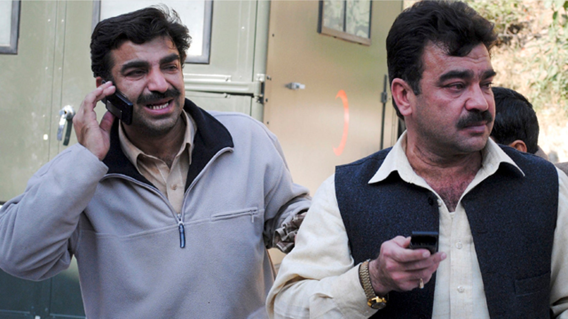 Dec. 25, 2010: Pakistani men weep as they stand beside their relative who was injured in the suicide bombing in Bajur tribal region.