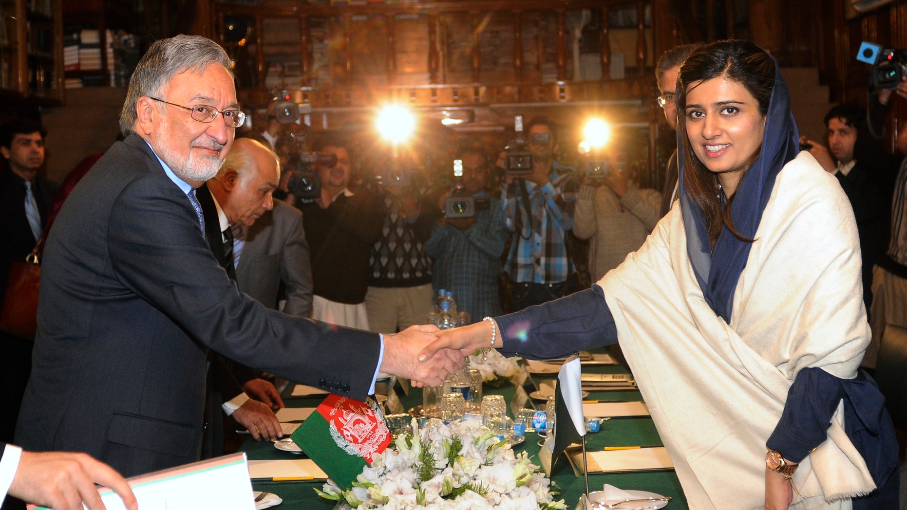 Nov. 30, 2012 - Afghan Foreign Minister Zalmay Rasoul, left, poses for photographers with his Pakistani counterpart Hina Rabbani Khar, prior to their meeting at the Foreign Office in Islamabad, Pakistan.