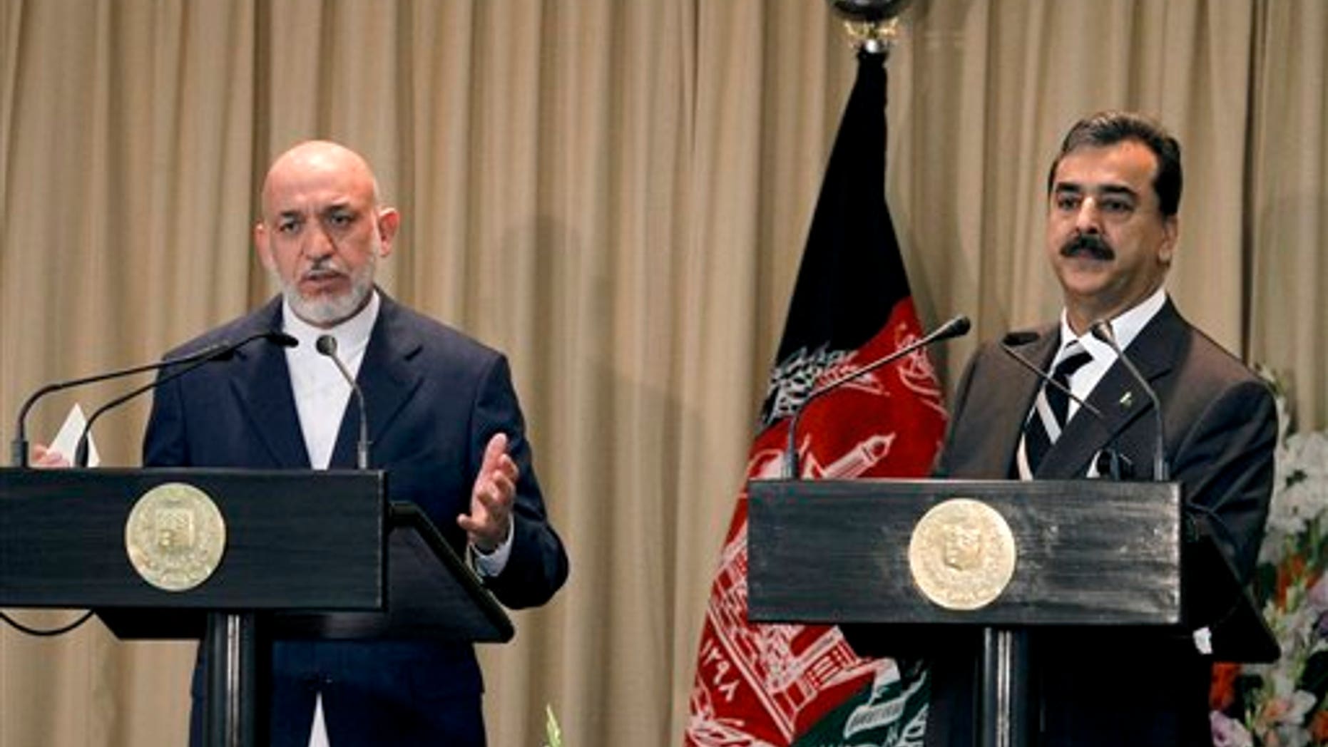 Afghan President Hamid Karzai, left, speaks, with Pakistani Prime Minister Yousuf Raza Gilani on the right, during a joint press conference in Islamabad, Pakistan.
