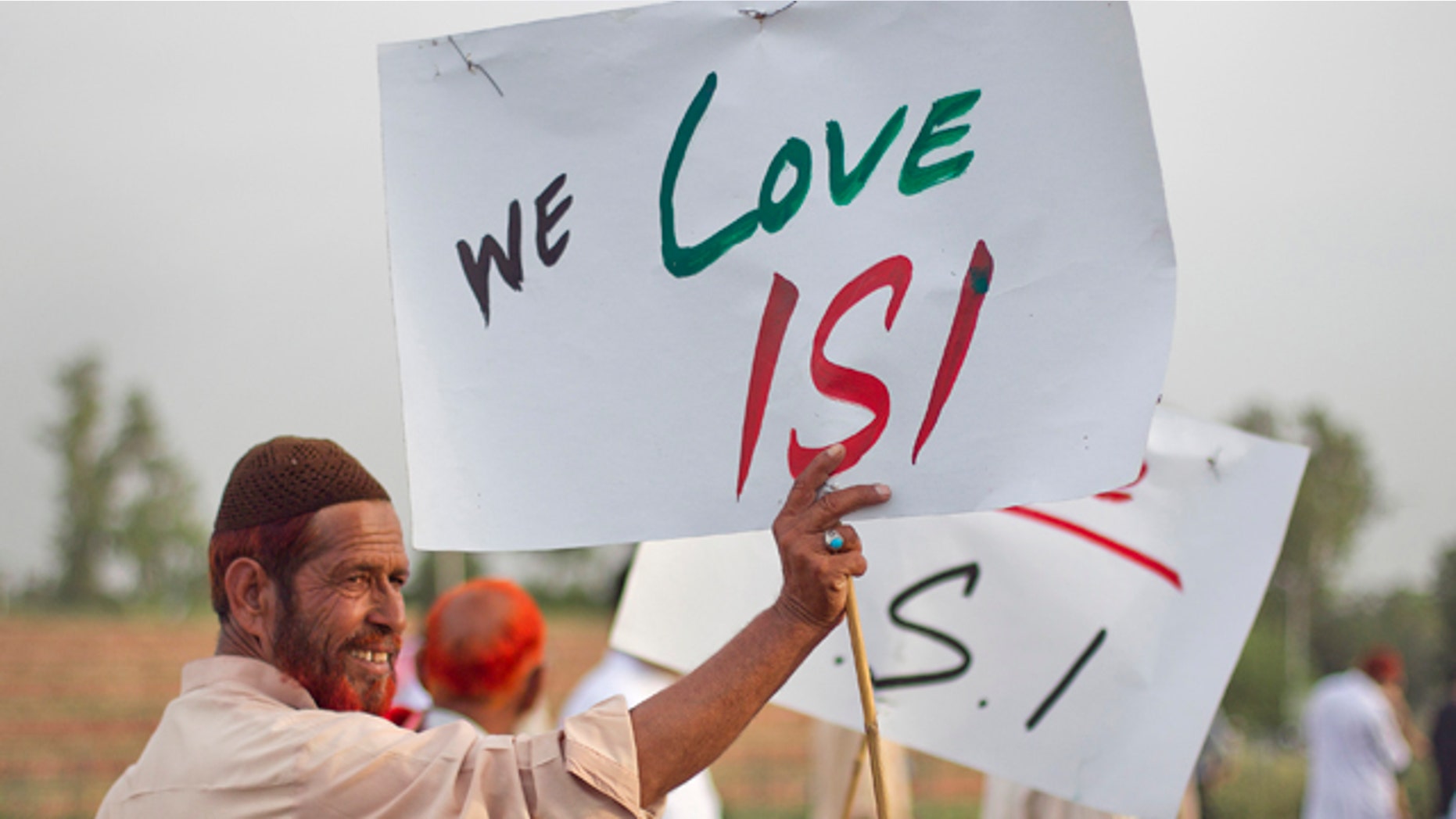 May 11, 2011: An activist associated with a social group from a citizen forum holds a placard as protesters rally in favor of Pakistan's army and Inter-Services Intelligence (ISI) in Islamabad.