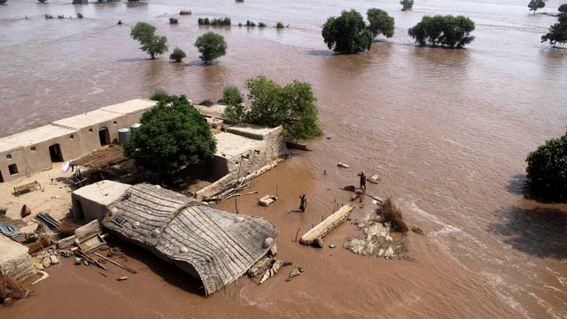September 12, 2014: Pakistani villagers wait to be rescued as they are stranded by flood waters in district Multan, Pakistan. (AP Photo/Mansoor Abass)