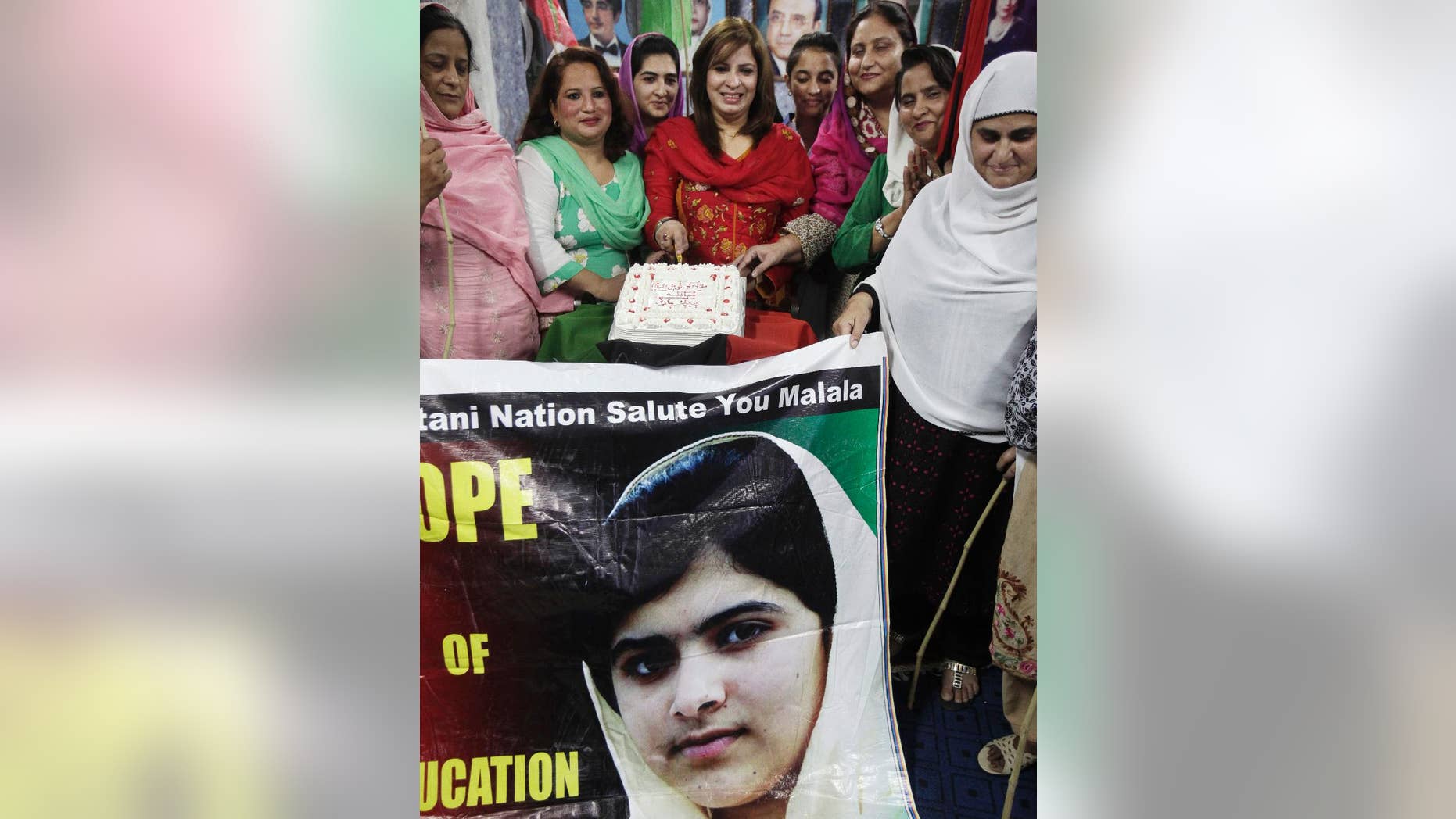 Female supporters of Pakistan People's Party cut a cake to celebrate Nobel Peace Prize winner Malala Yousafzai, who survived the Taliban's attack, at a ceremony in Islamabad, Pakistan, Saturday, Oct. 11, 2014. Taliban attack survivor Malala became the youngest Nobel winner ever as she and Kailash Satyarthi of India won the Nobel Peace Prize on Friday for working to protect children from slavery, extremism and child labor at great risk to their own lives. (AP Photo/Anjum Naveed)