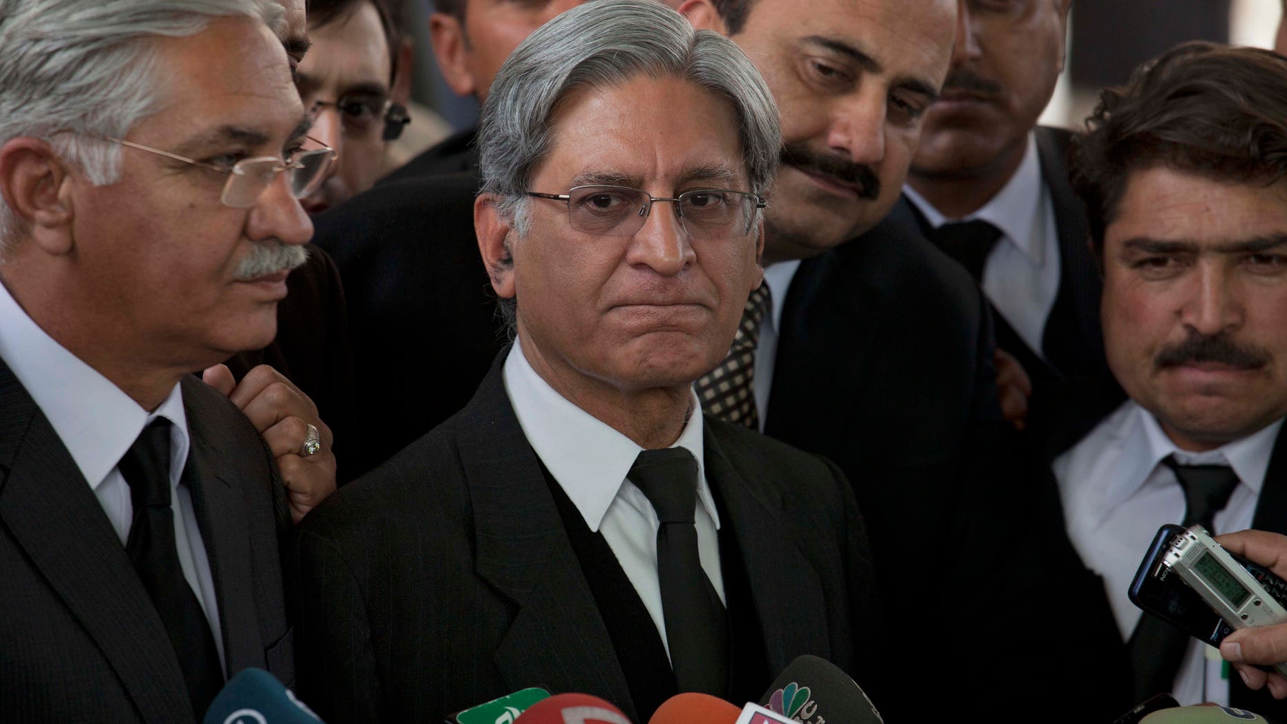 Feb. 2, 2012: Aitzaz Ahsan, center, lawyer of Pakistan's Prime Minister Yusuf Raza Gilani listens to reporters outside the Supreme Court in Islamabad, Pakistan.
