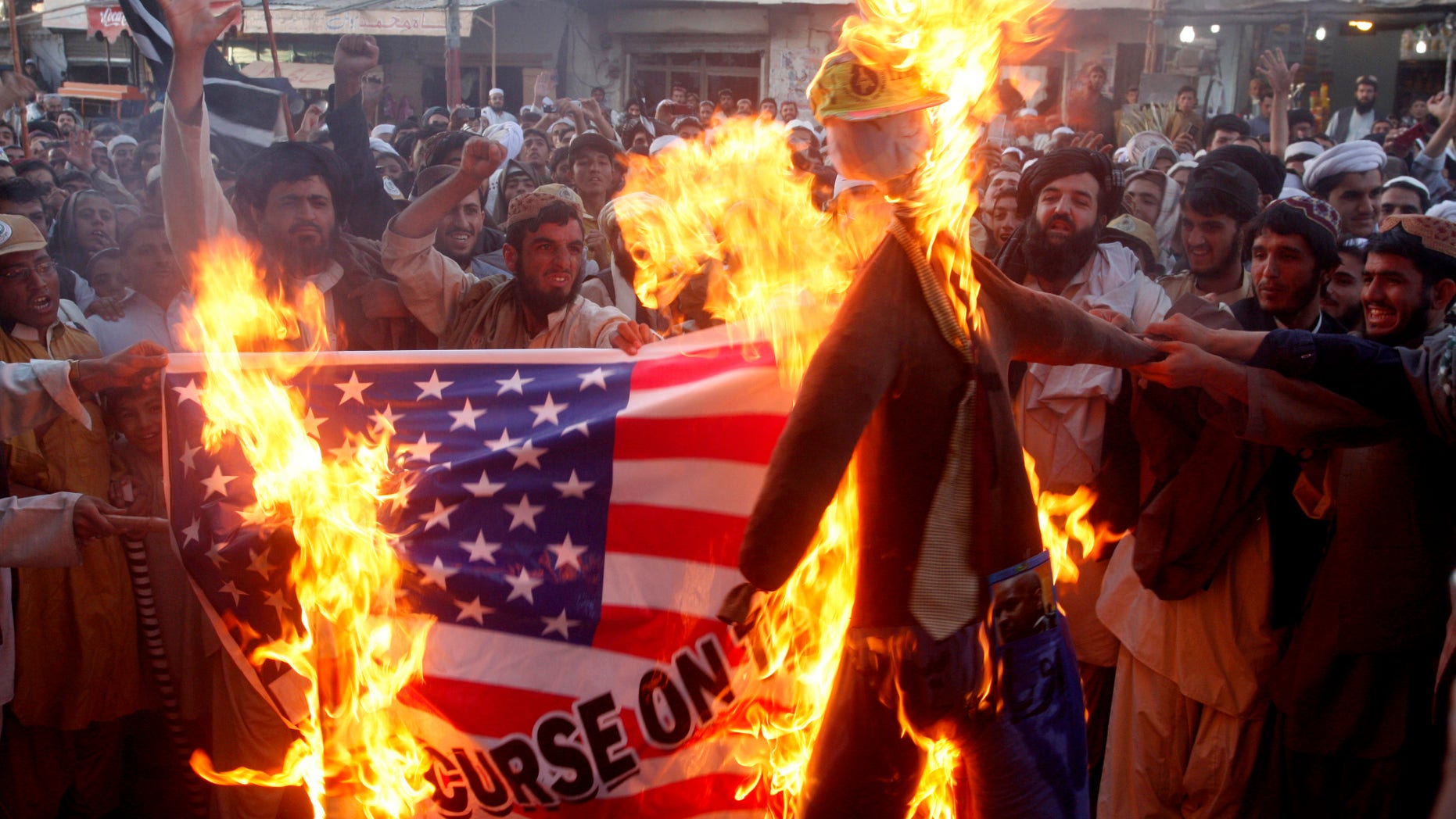 FILE - In this Thursday, Sept. 20, 2012 file photo, Pakistani protesters burn a representation of a U.S. flag and an effigy of U.S. President Barack Obama in the Pakistani border town of Chaman along the Afghanistan border. U.S.-funded ads on Pakistani television include President Barack Obama extolling Americas religious tolerance. To many in the Muslim world, this misses the mark in efforts to calm the outrage over a film mocking the Prophet Muhammad. (AP Photo/Matiullah Achakzai, File)