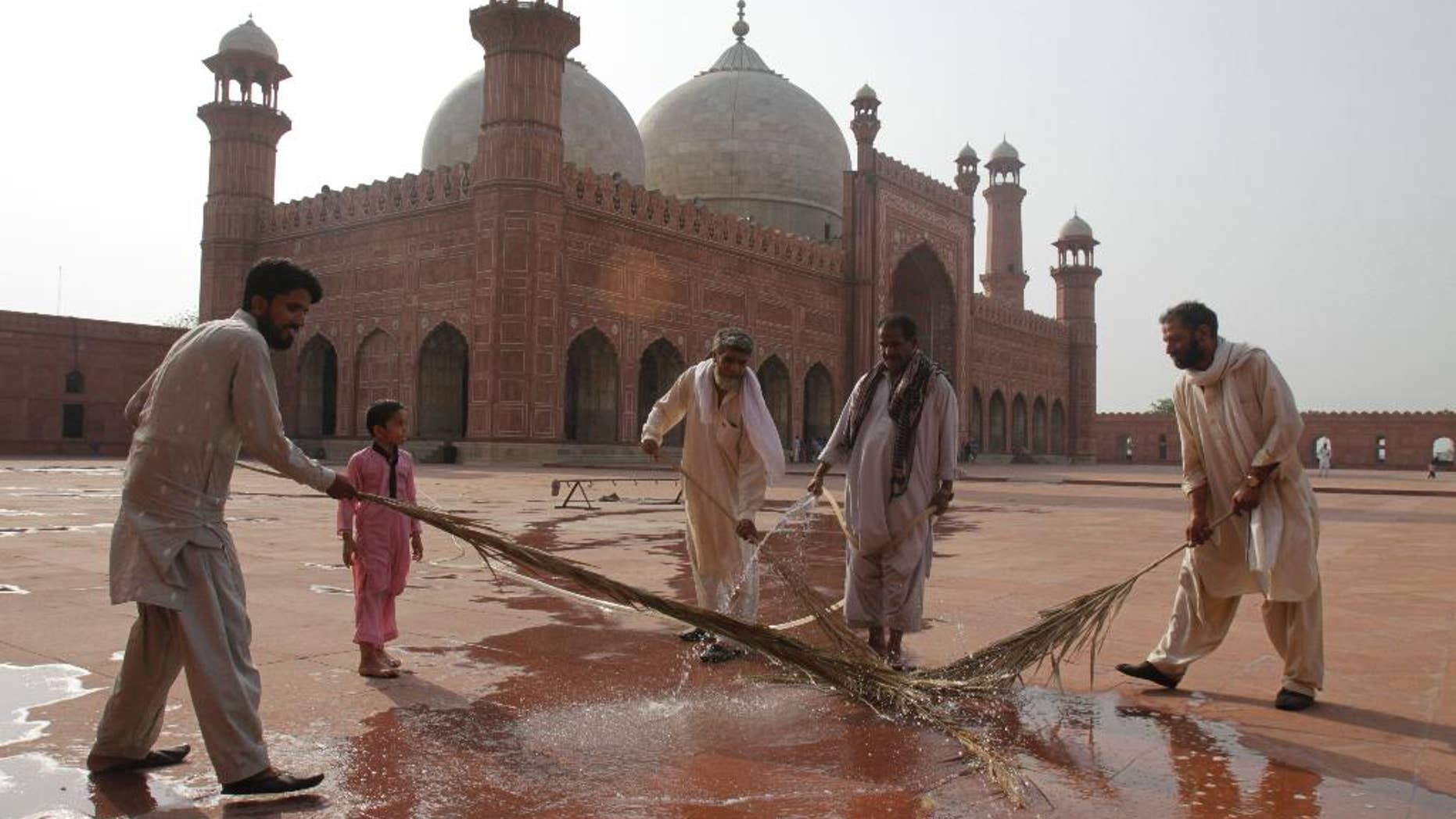 Preparations are in progress for the upcoming Ramadan at the 17th century Badshahi mosque in Lahore, Pakistan, Wednesday, June 17, 2015. Muslims throughout the world mark the month of Ramadan, the holiest month in the Islamic calendar, with dawn to dusk fasting. (AP Photo/K.M. Chaudary)