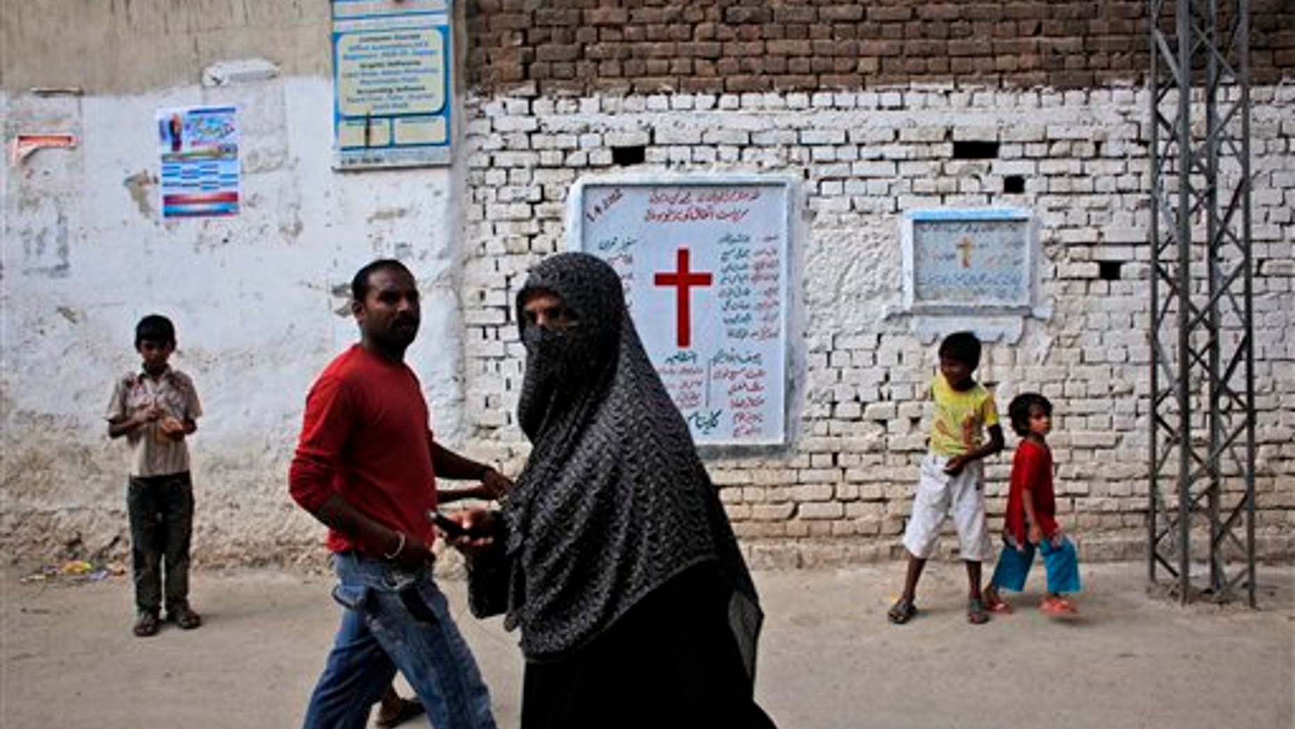 Aug. 30, 2012: Pakistanis walk in a Christian neighborhood in Islamabad, Pakistan.